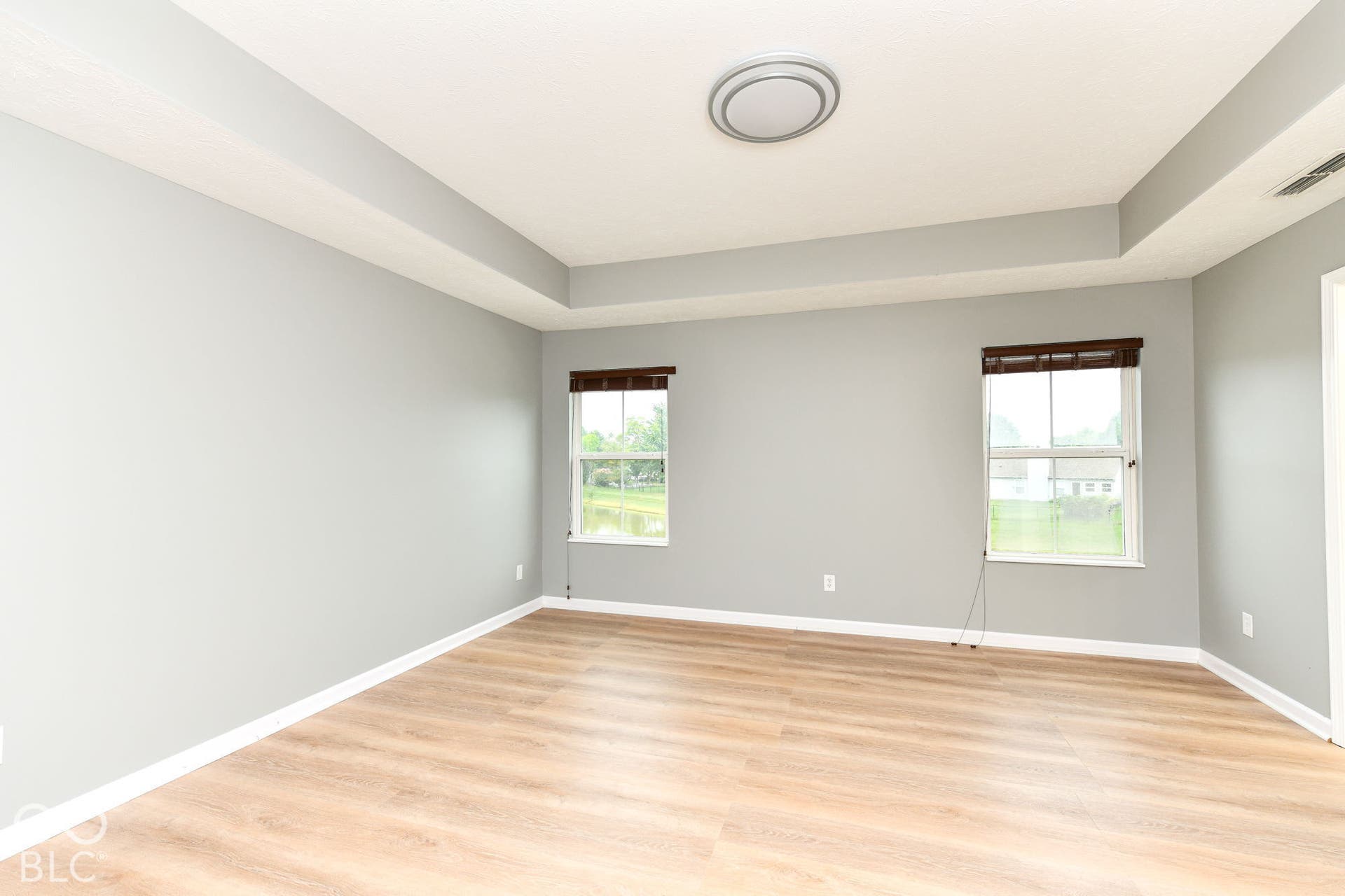 Tray ceiling with a modern flush-mount light fixture