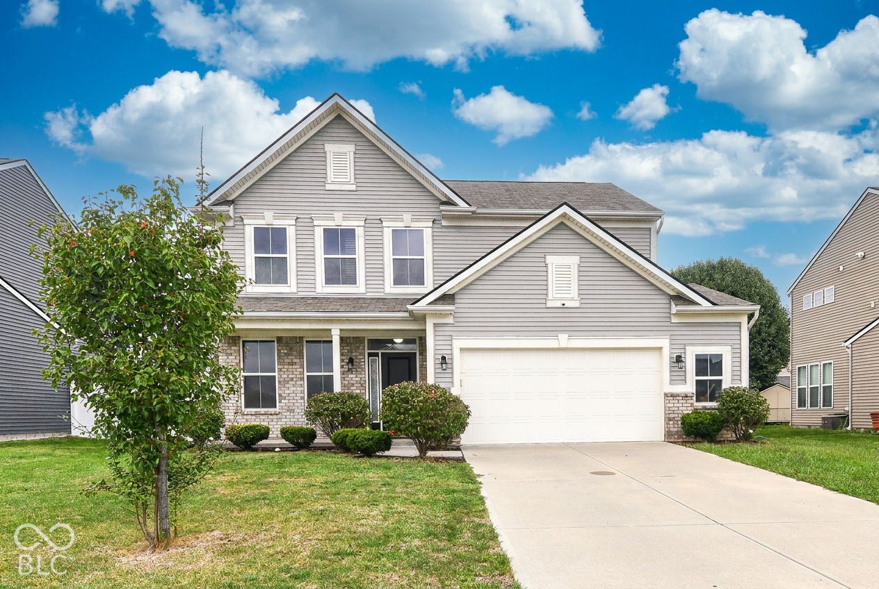 Two-story exterior with light gray siding and brick accents