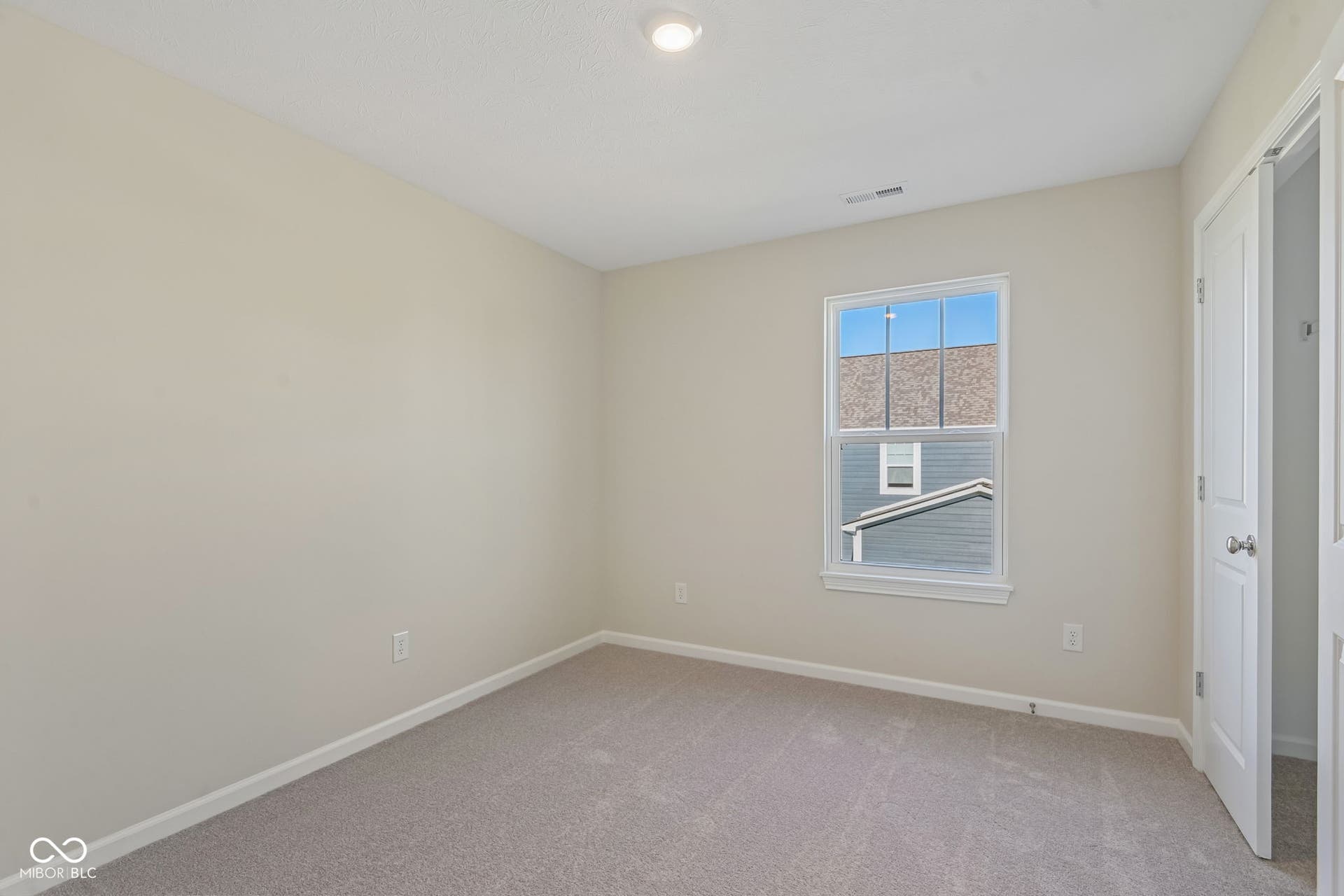 Neutral tone walls with carpeting and white trim