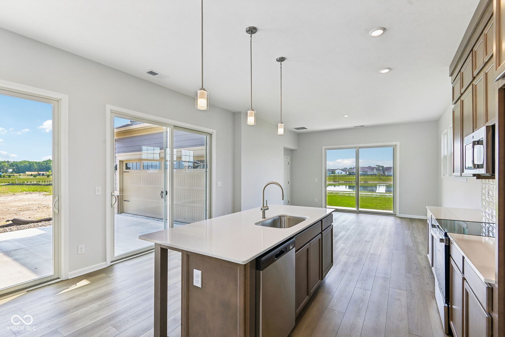 15762 Showdown Road, Noblesville, IN 46060 Modern kitchen featuring a central island with an undermount sink and pendant lighting