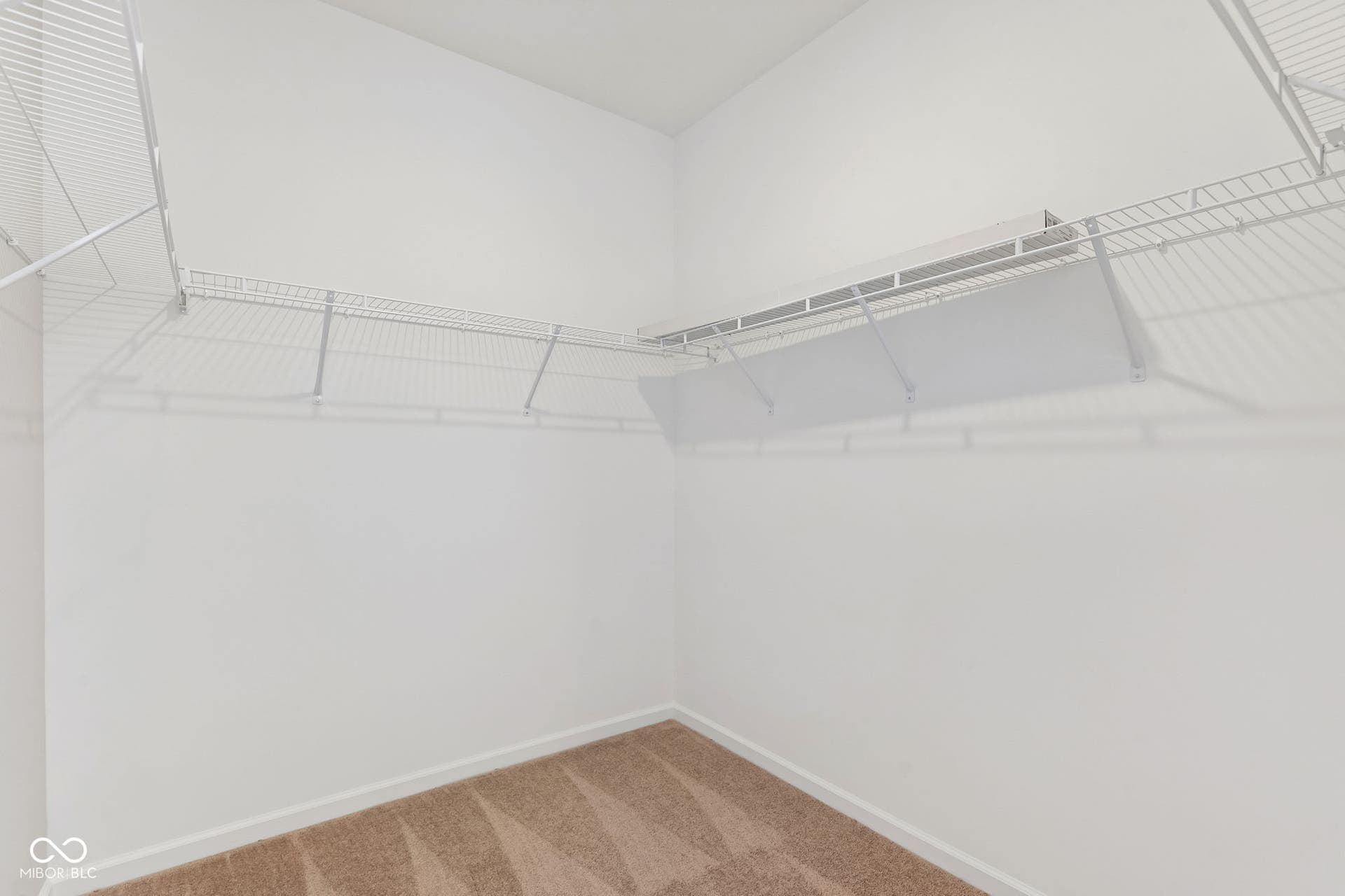 15762 Showdown Road, Noblesville, IN 46060 Walk-in closet featuring white wire shelving, white walls, and neutral carpet flooring