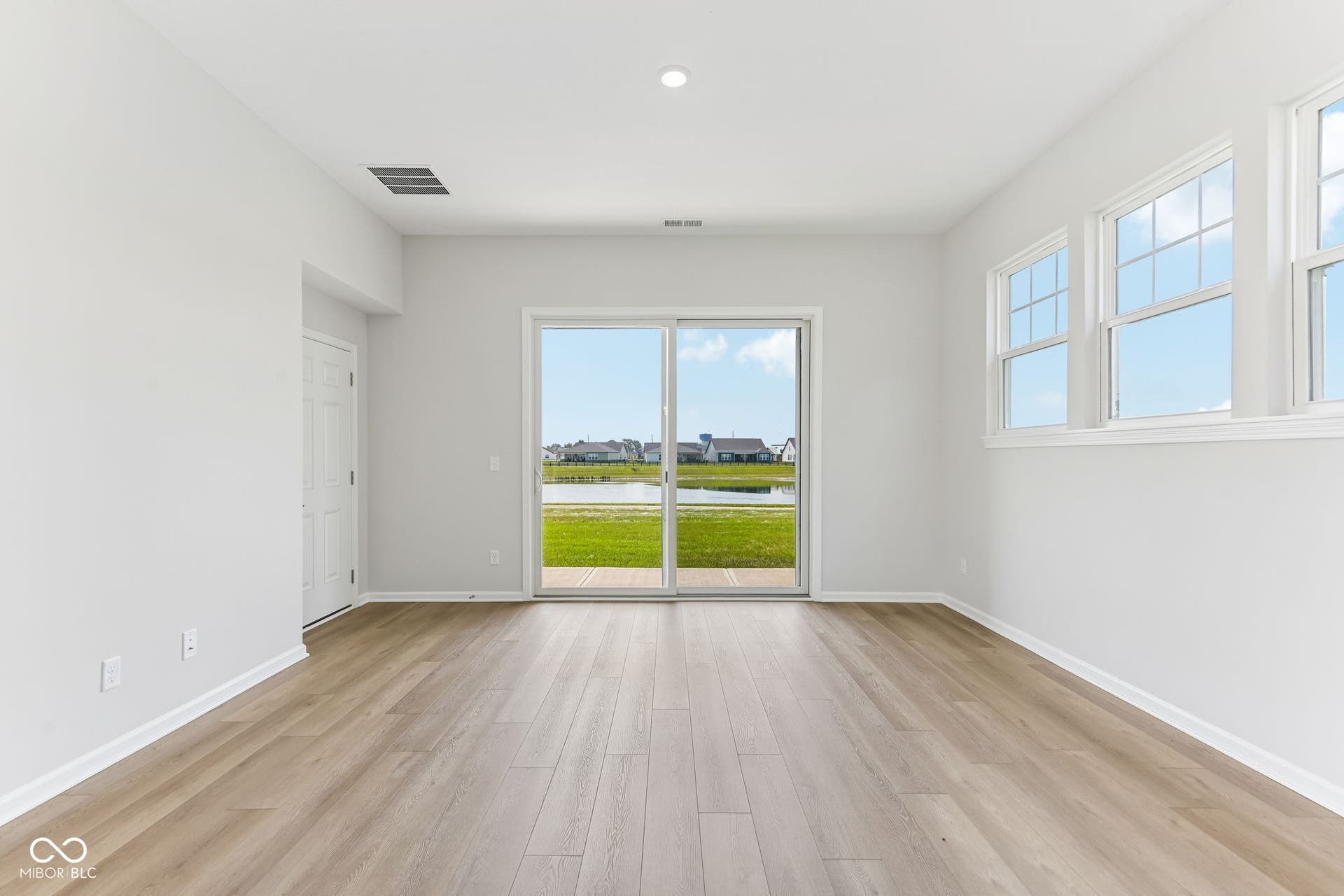 15762 Showdown Road, Noblesville, IN 46060 Bright interior space featuring light wood-finish flooring, white baseboards, and neutral wall tones