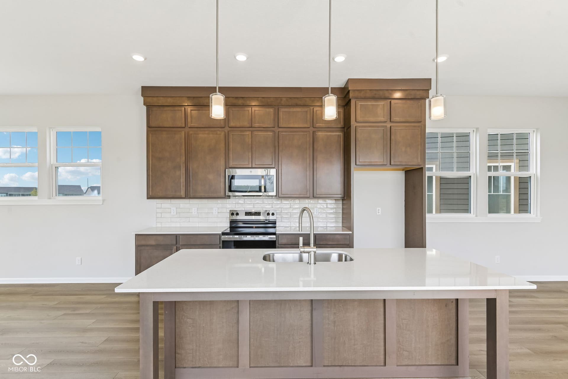 15762 Showdown Road, Noblesville, IN 46060 Contemporary kitchen featuring a large central island with a double basin sink and a single-handle faucet