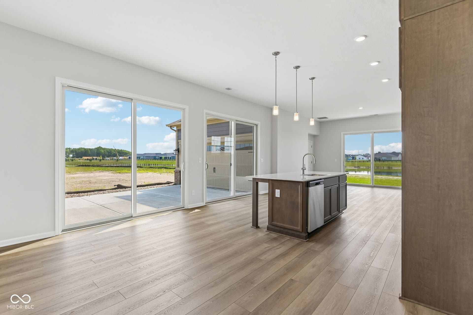 15762 Showdown Road, Noblesville, IN 46060 Open-concept living space featuring wood-finish flooring and extensive natural light