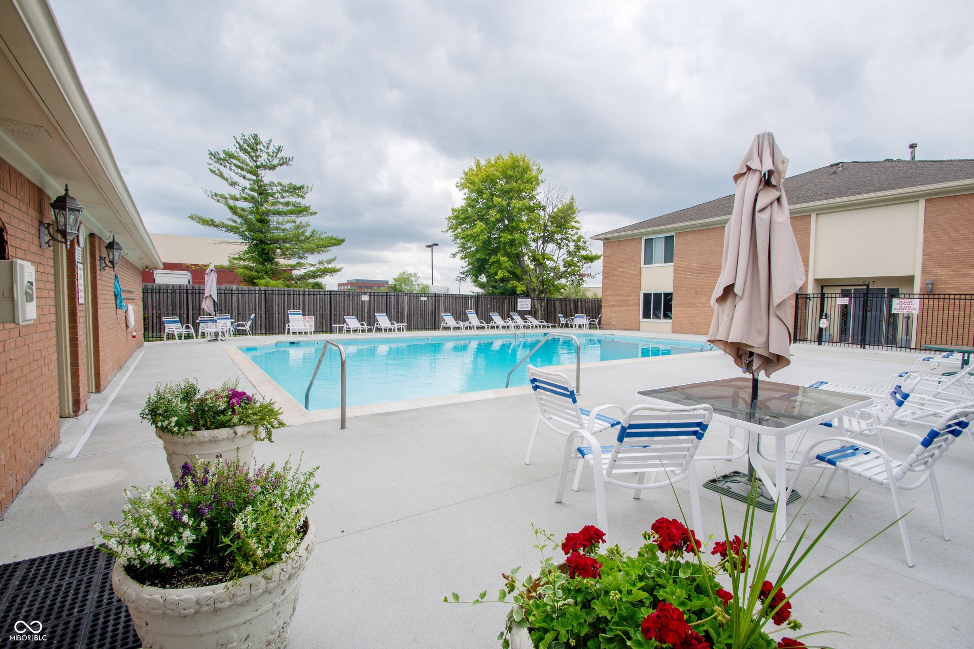 Outdoor swimming pool with integrated steps, surrounded by a concrete deck
