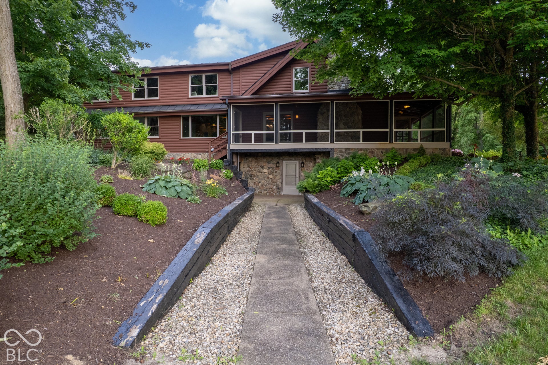 Brown wood-sided exterior featuring multiple windows and a screened porch