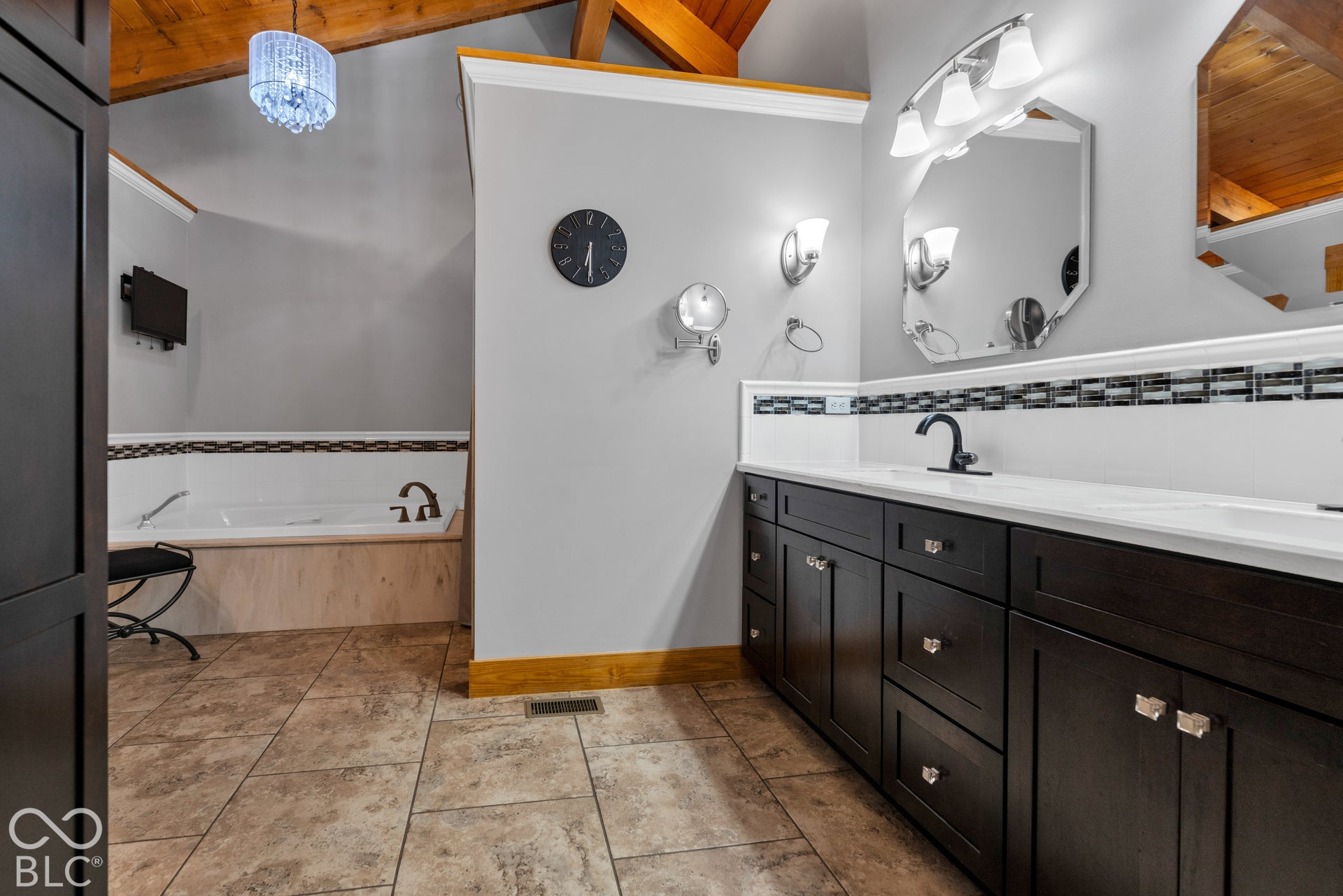 Double vanity with dark wood-finish cabinetry and white countertops