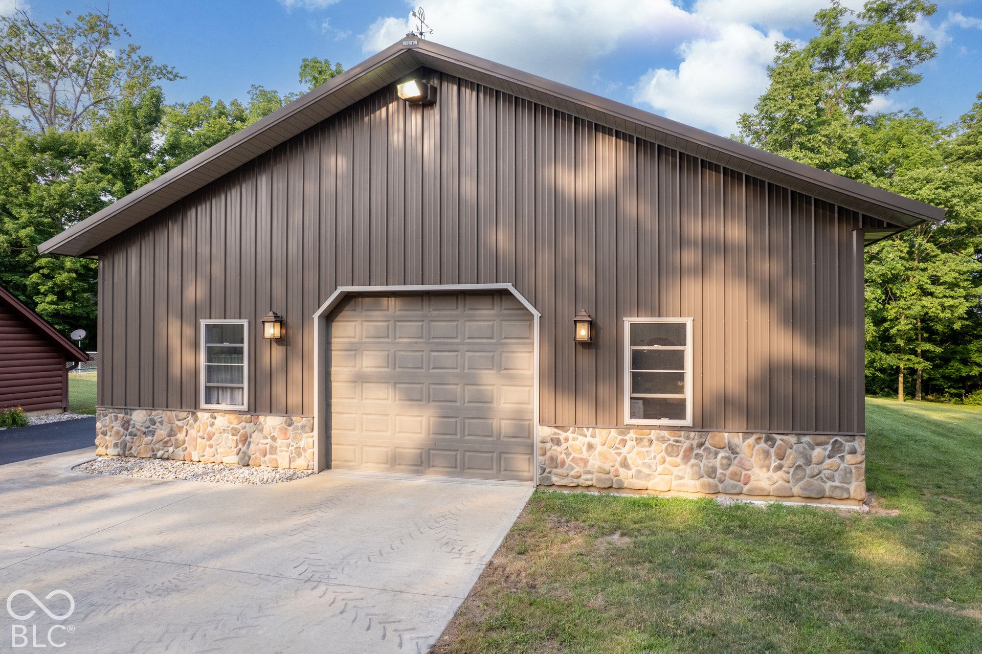 Metal-sided building with a stone-finish foundation