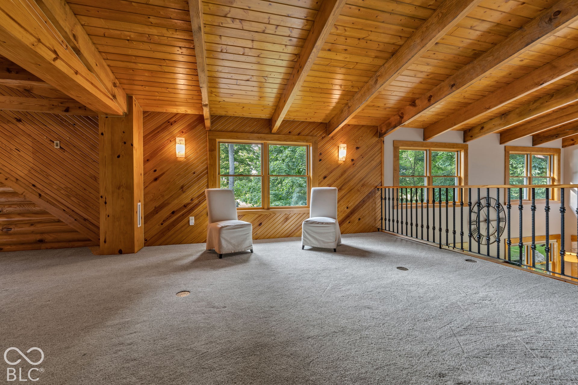 Wood-paneled walls and exposed beam ceiling