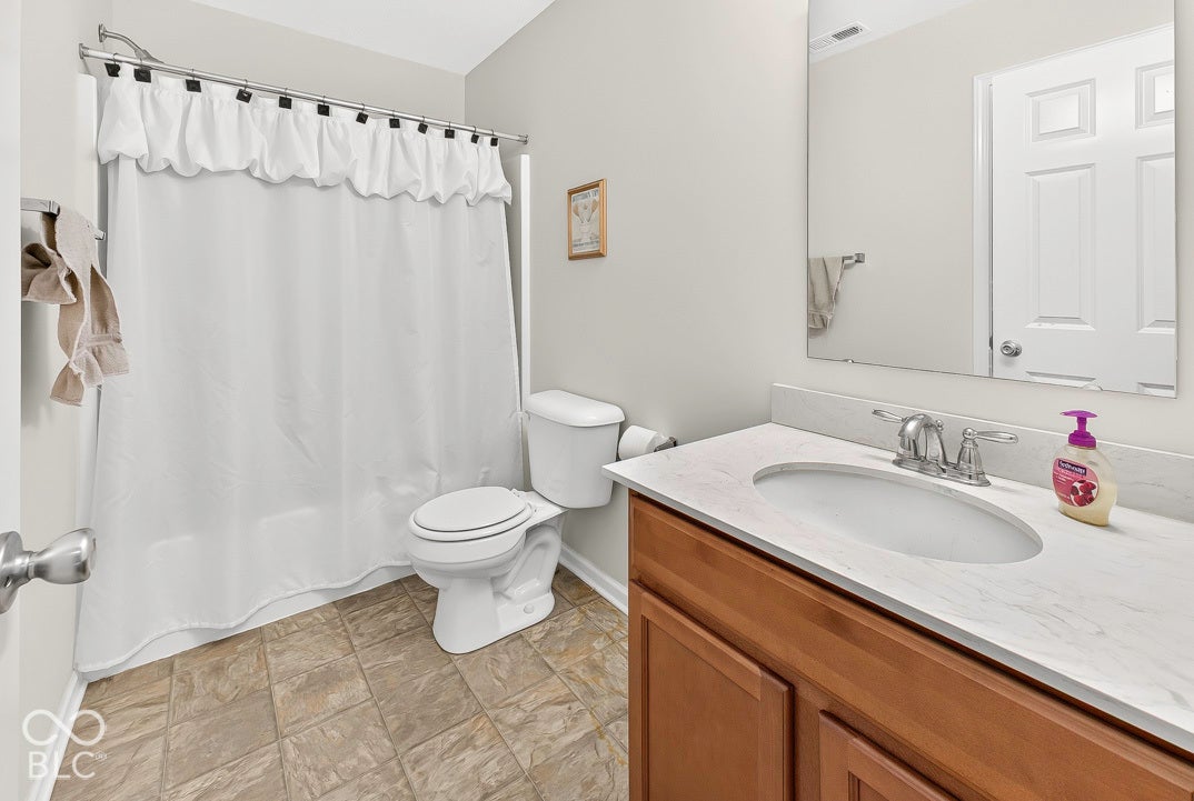 Vanity with a light-toned countertop, undermount sink, and chrome fixtures