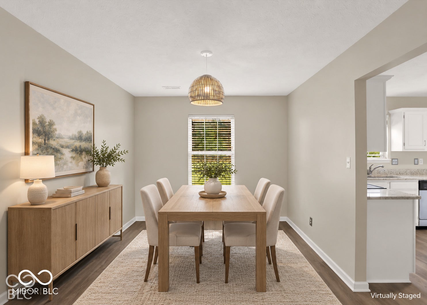 Recessed lighting, wood-finish flooring, and a decorative pendant light fixture