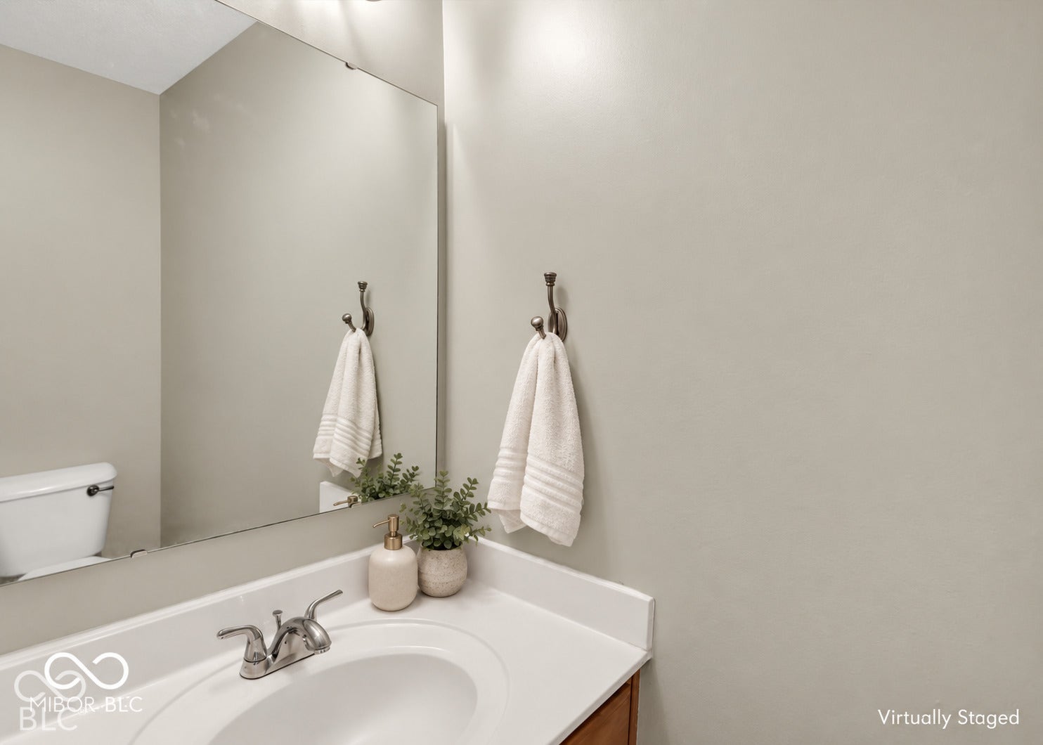 Integrated vanity with a white countertop and a single basin sink