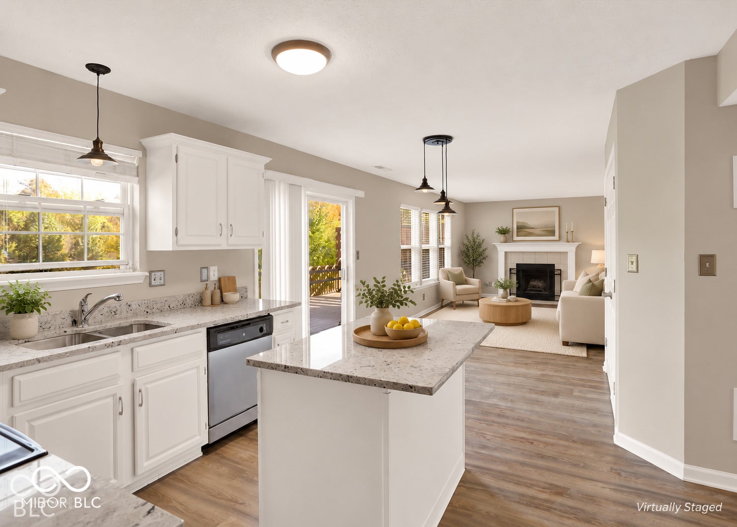 Open-concept living space featuring a fireplace, wood-finish flooring, white cabinetry, granite countertops, and an island