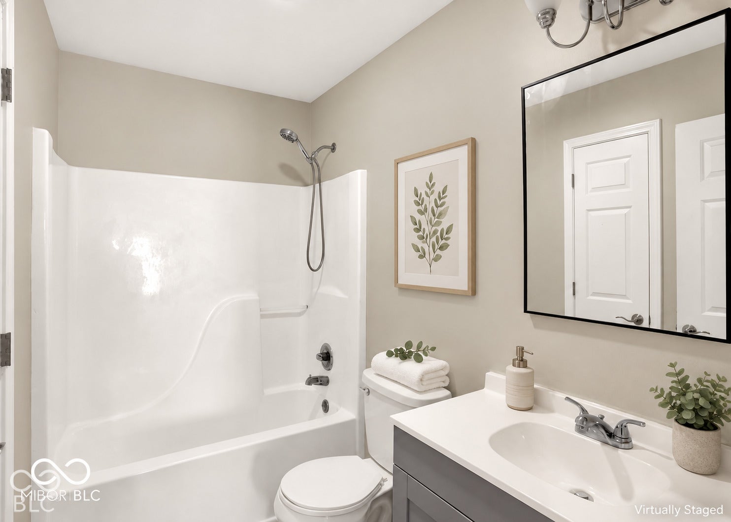 White tub and shower combination with chrome fixtures