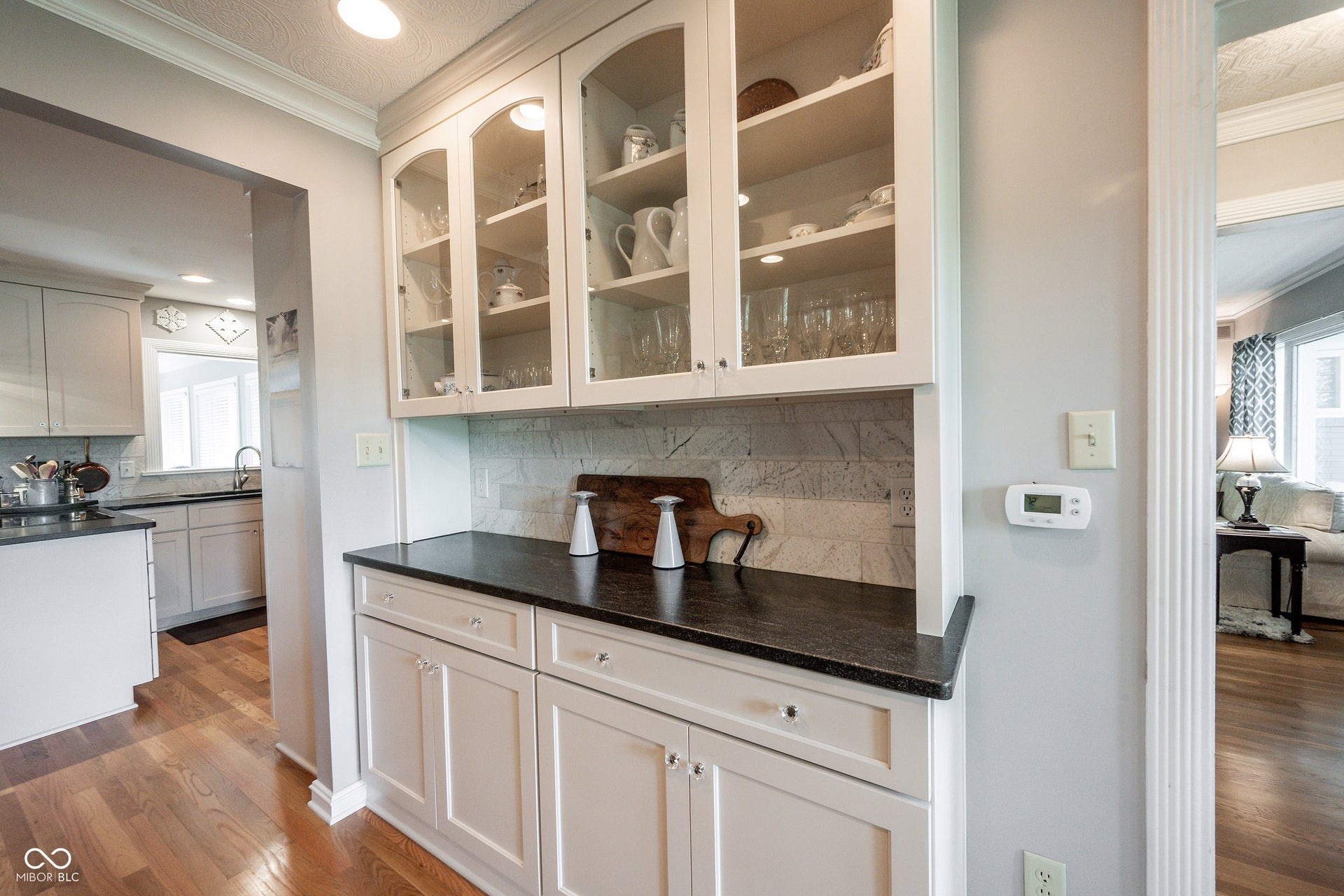 Custom Built In Buffet with Class Doors upper Doors, Custom Tile Marble Backsplash and honed Granite Countertop
