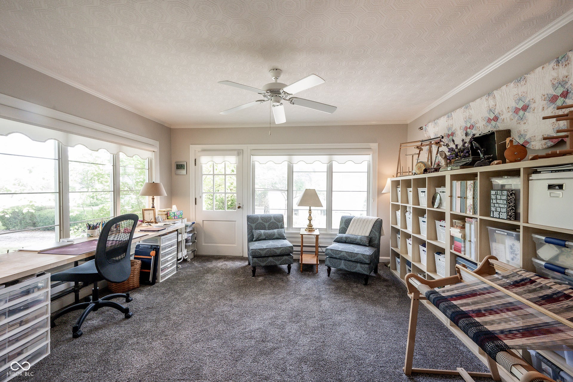 This Sun Room - currently being used as a Craft Room - is flooded with light...waiting for the next owner to use as a Den, Library, Home Office, Playroom and has an outside access door to the driveway. Crown Molding