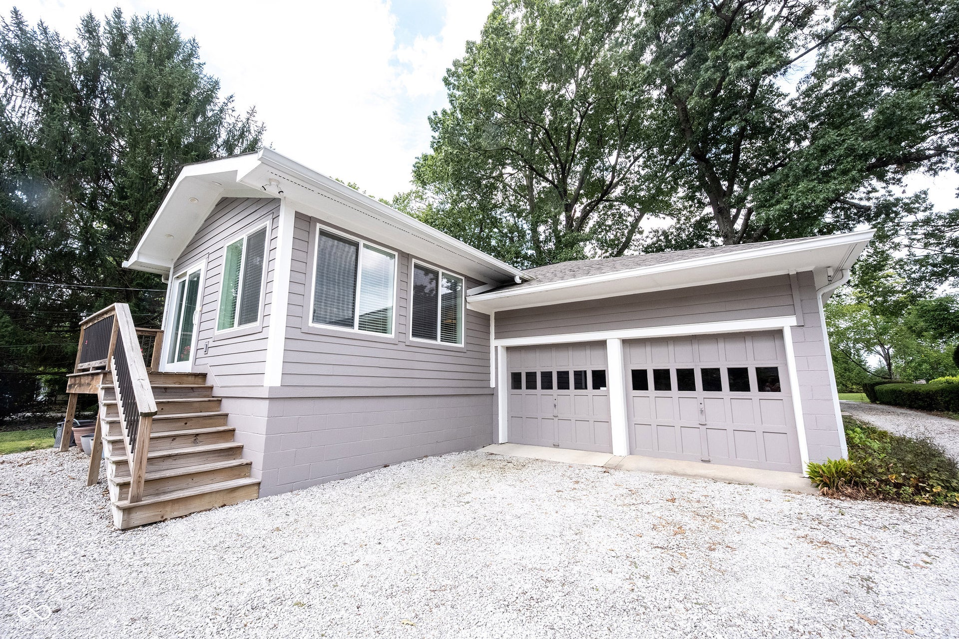 View of Stairs/Landing Entrance to Family Room and Double Garage Doors to Backload Garage