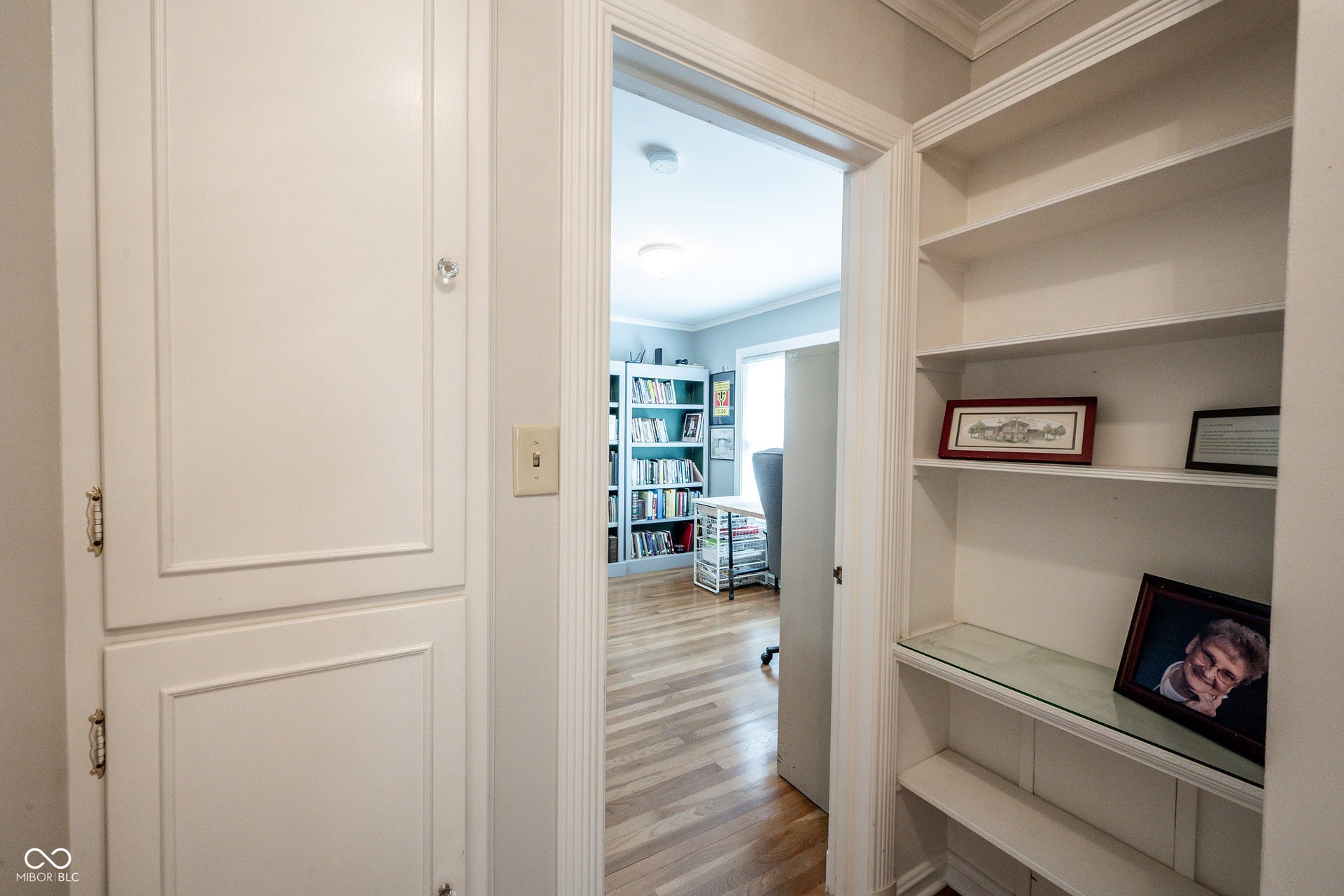 Hallway between Bedroom 2 and Bedroom 3 with Custom Built in bookcase and storage
