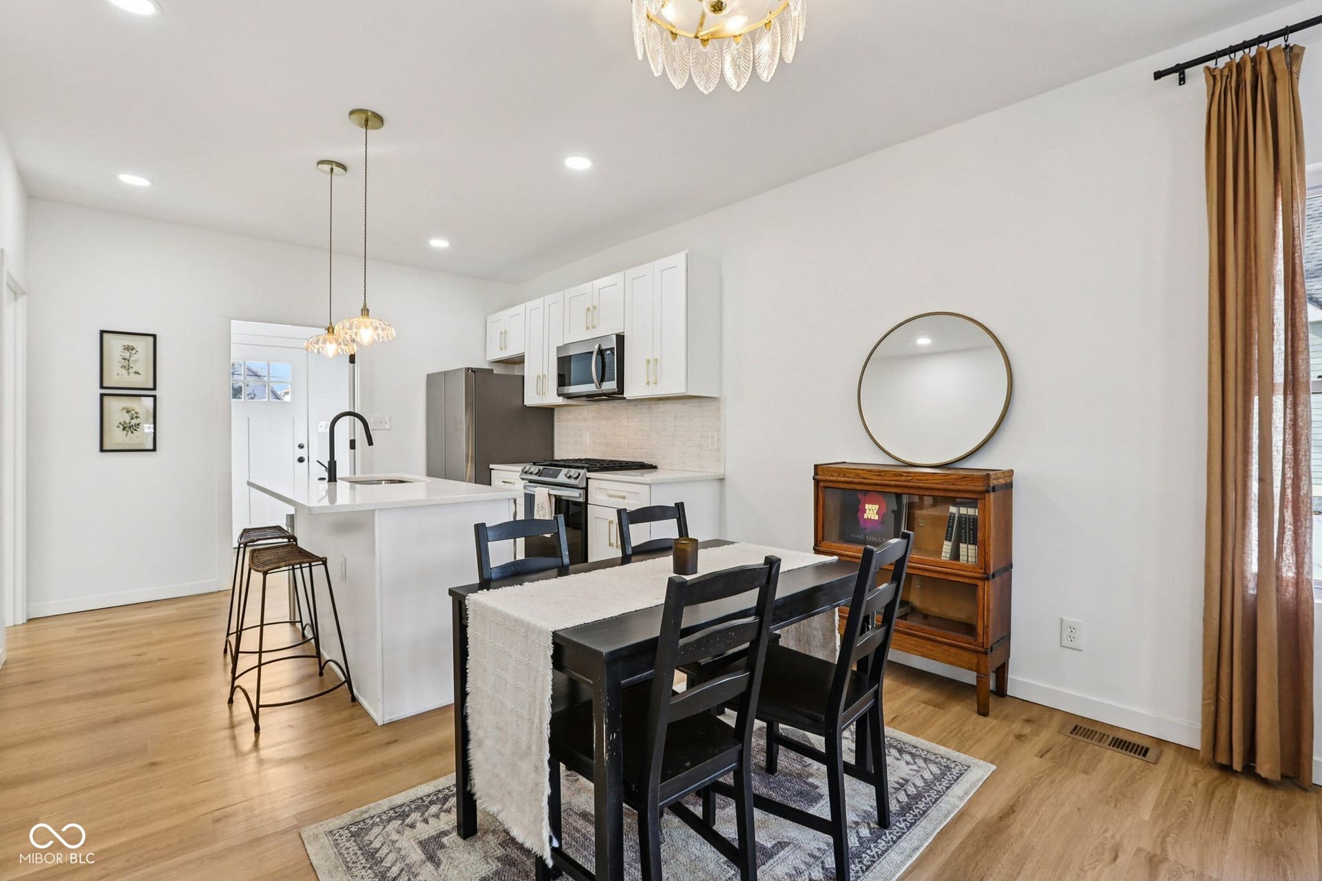 Open-concept kitchen and dining area featuring light wood-finish flooring