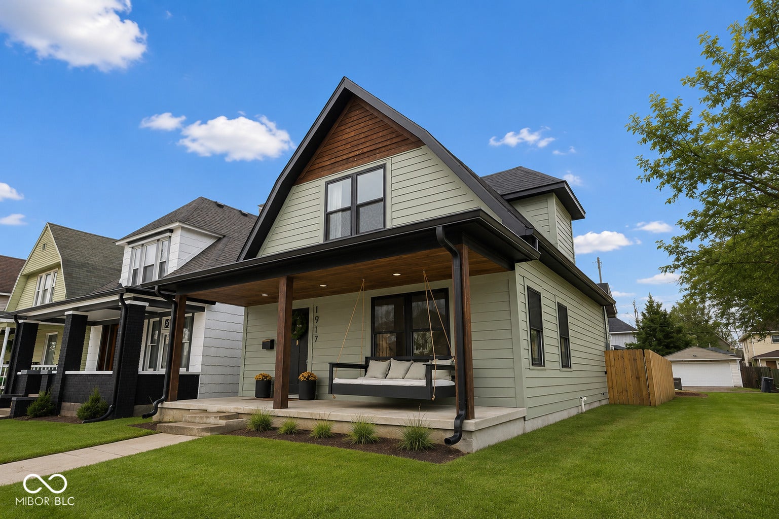 Virtually Altered - Two-story residence featuring light-colored siding and a dark roof