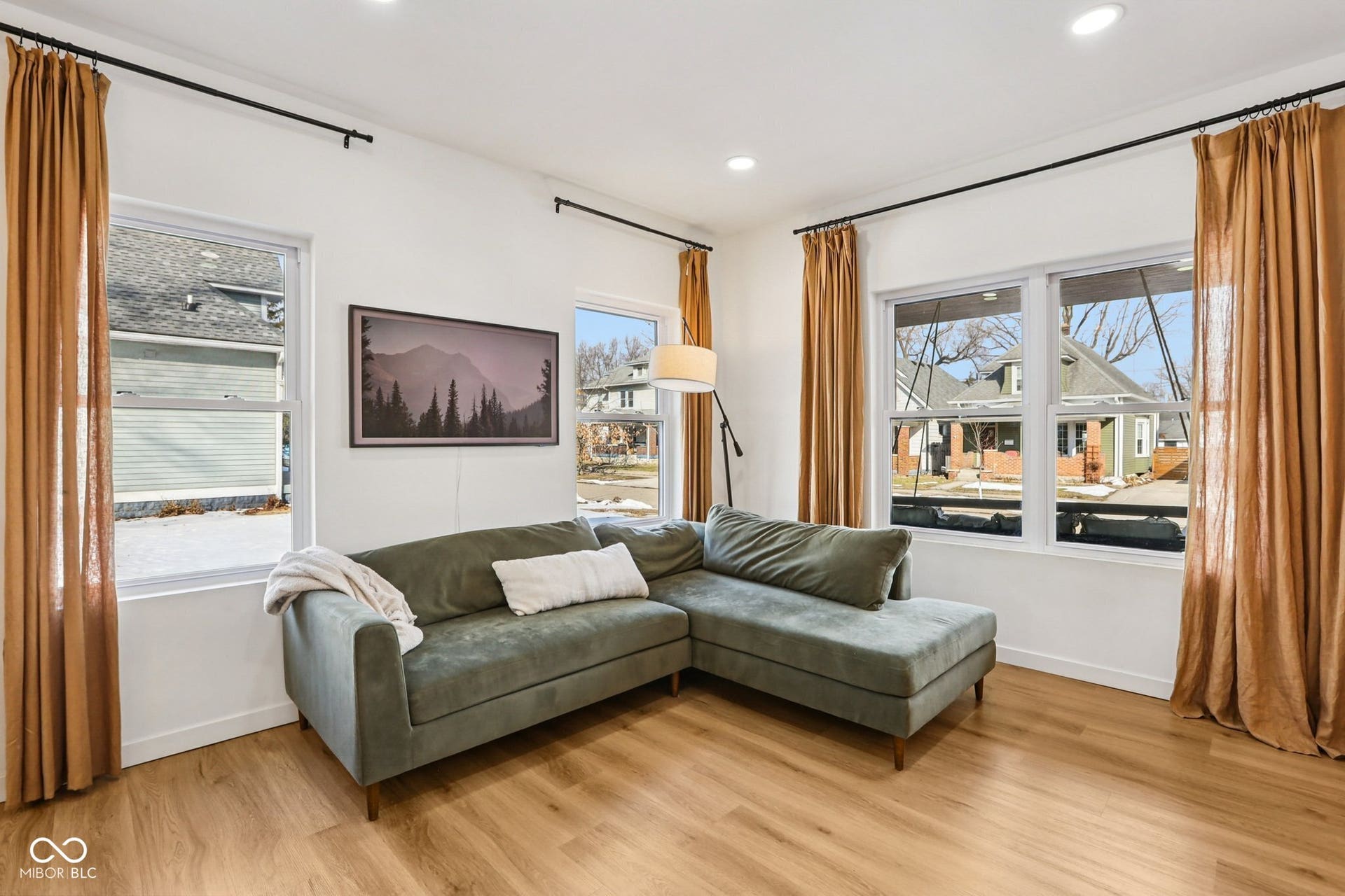 Open living space featuring wood-finish flooring and white walls