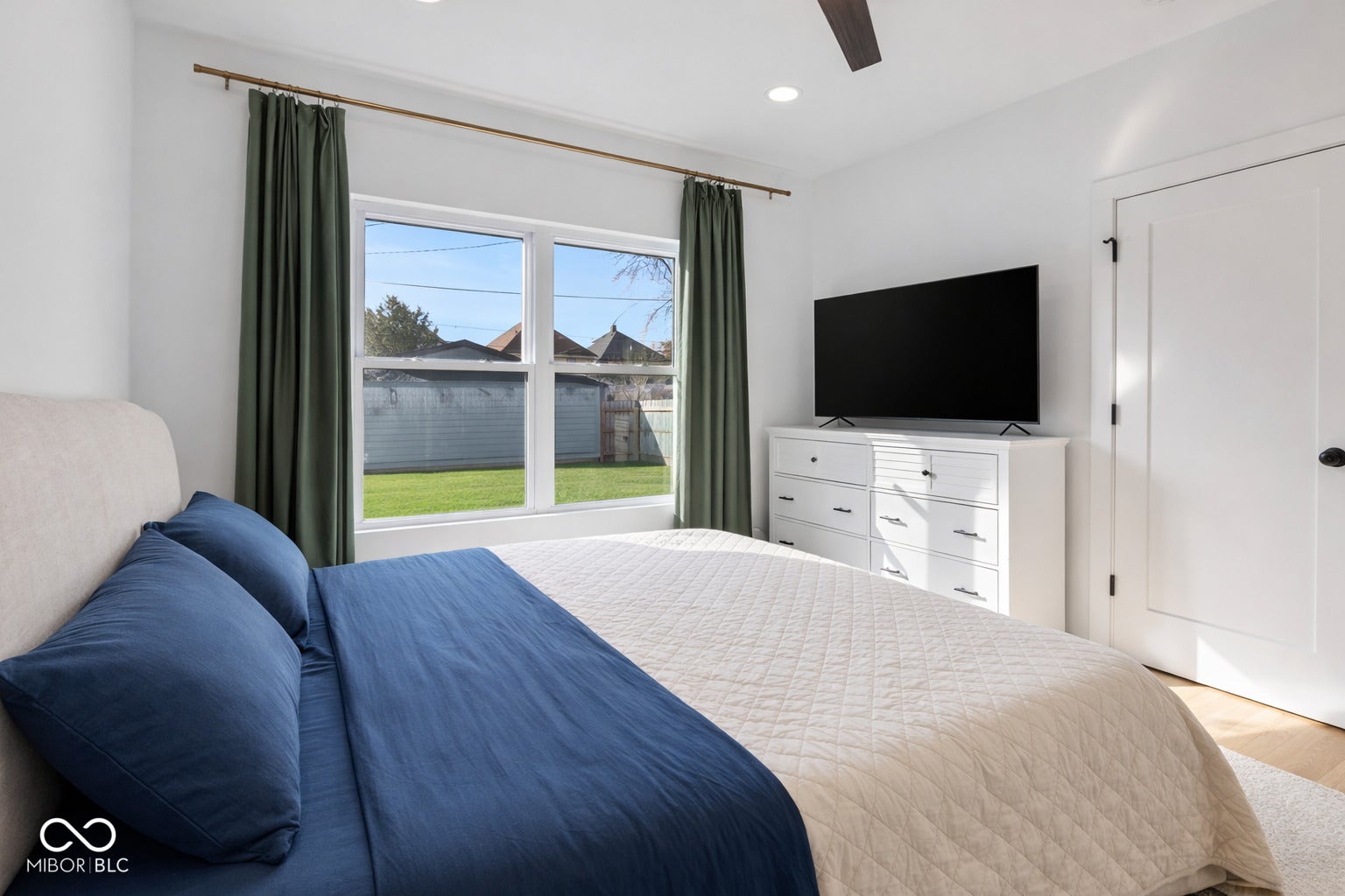 Bright interior with white walls, recessed lighting, and a ceiling fan