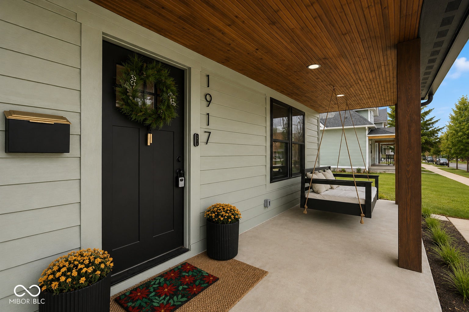 Virtually Altered - Front porch featuring a rich wood-finish ceiling, recessed lighting, concrete flooring, and a substantial wood-finish support column