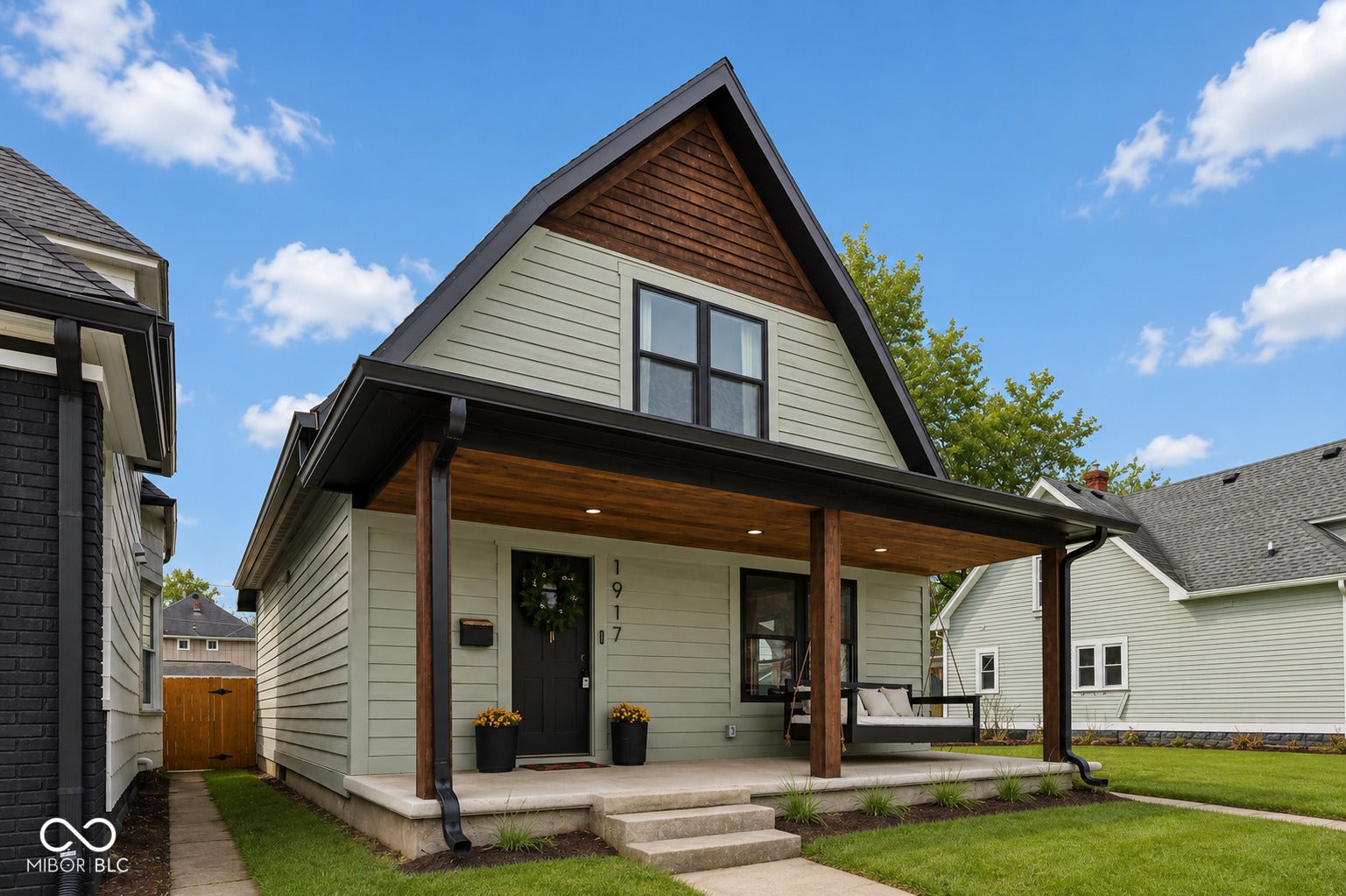 Virtually Altered - Modern bungalow with light green siding and dark trim accents