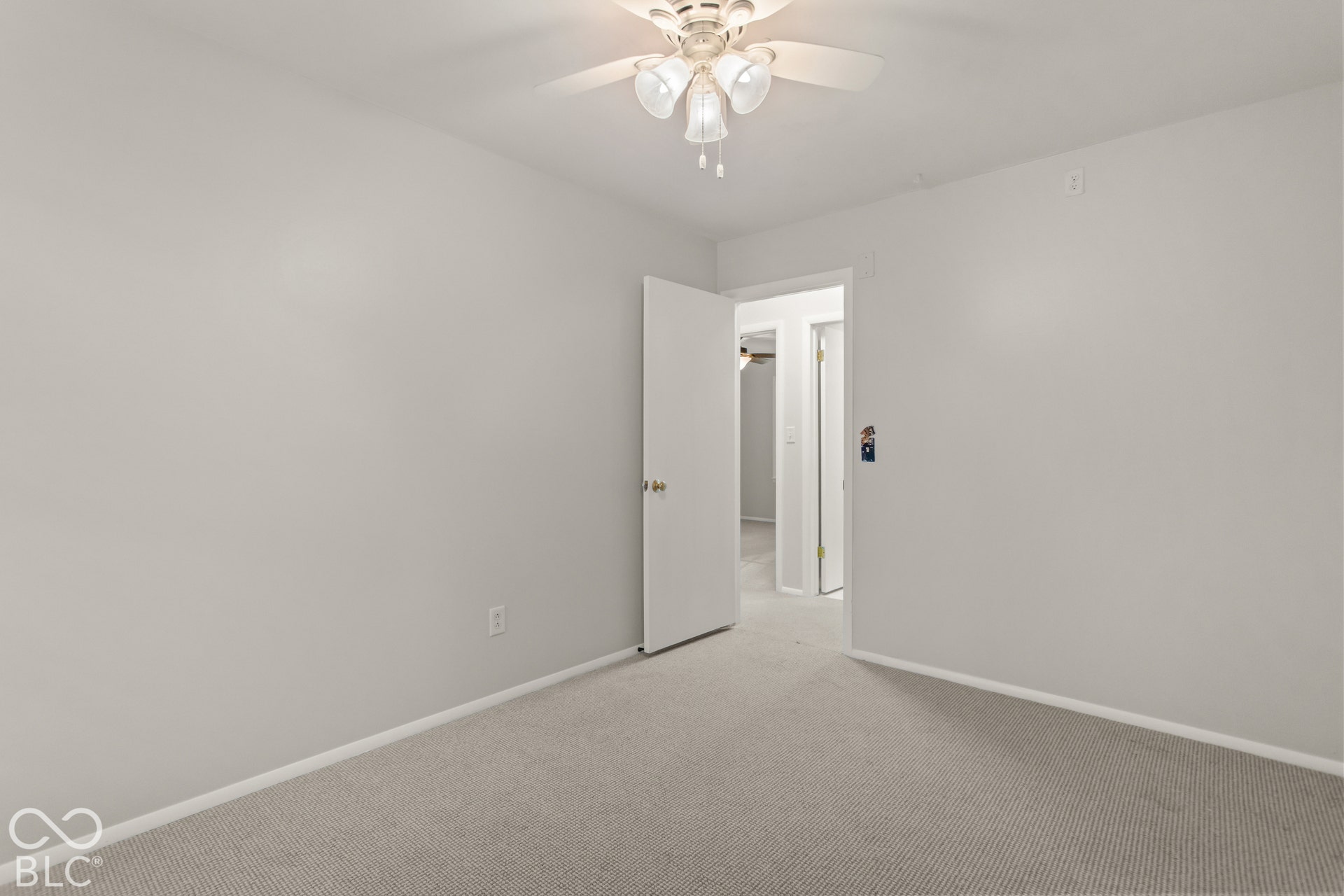 Wall-to-wall carpeting with light gray walls and a ceiling fan with integrated lighting