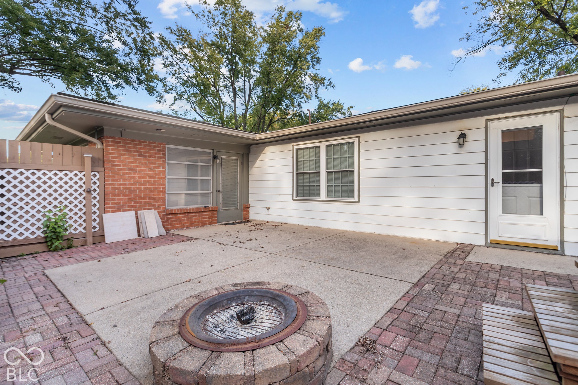 Patio with concrete and brick paver surfaces, integrated brick fire pit, Hot tub