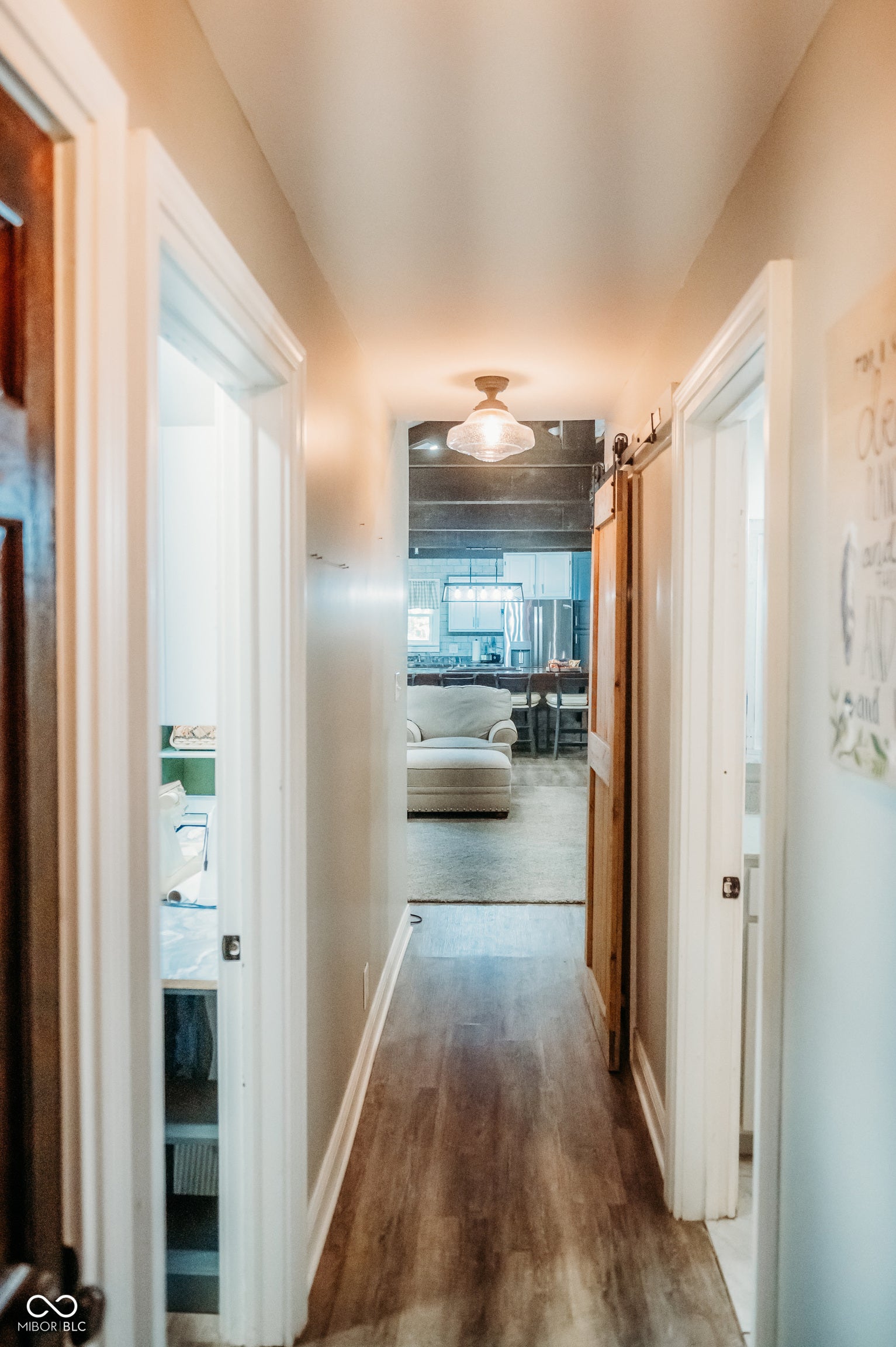Hallway with wood-finish flooring and white trim