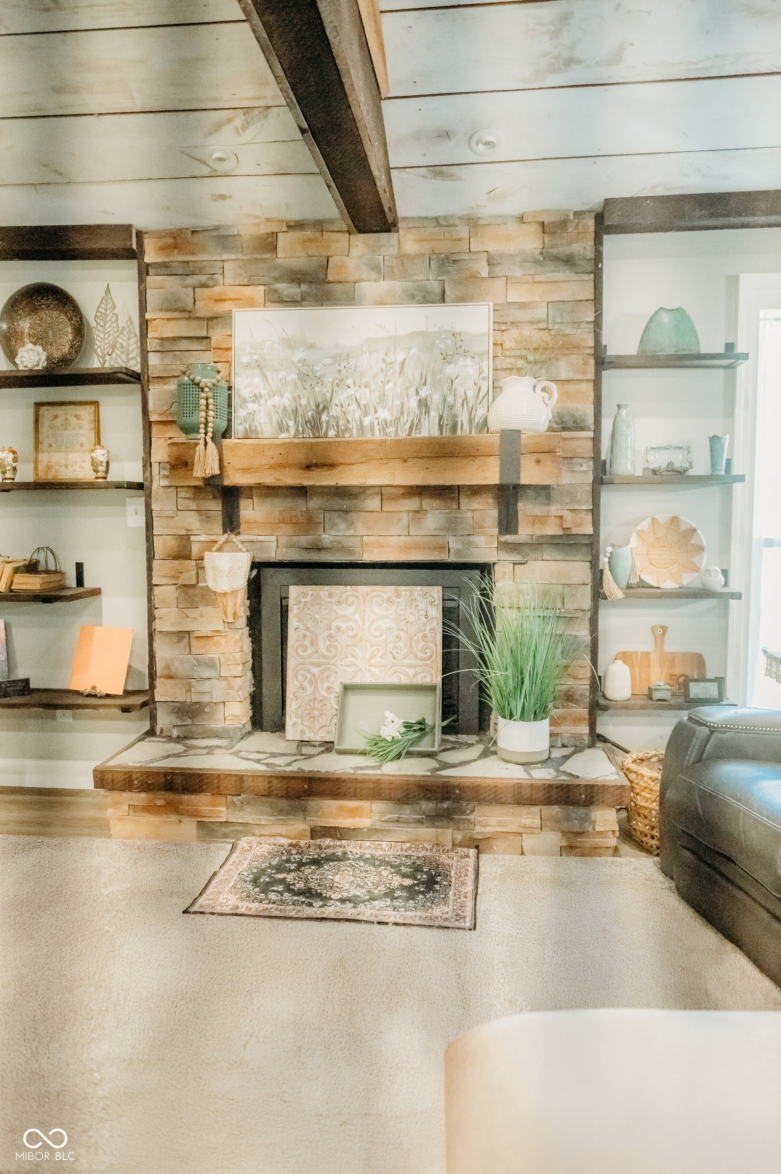 Stone-clad fireplace with a wood mantel and hearth