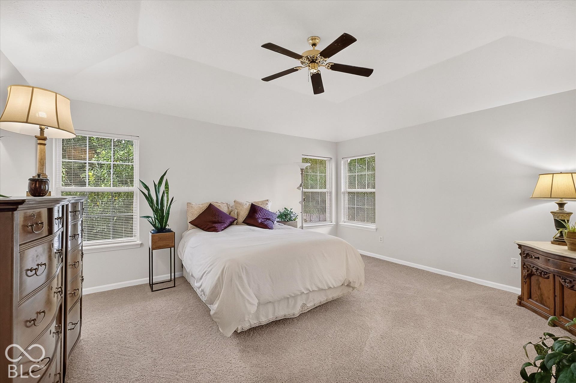 Spacious primary bedroom with ceiling fan, natural light and ensuite.