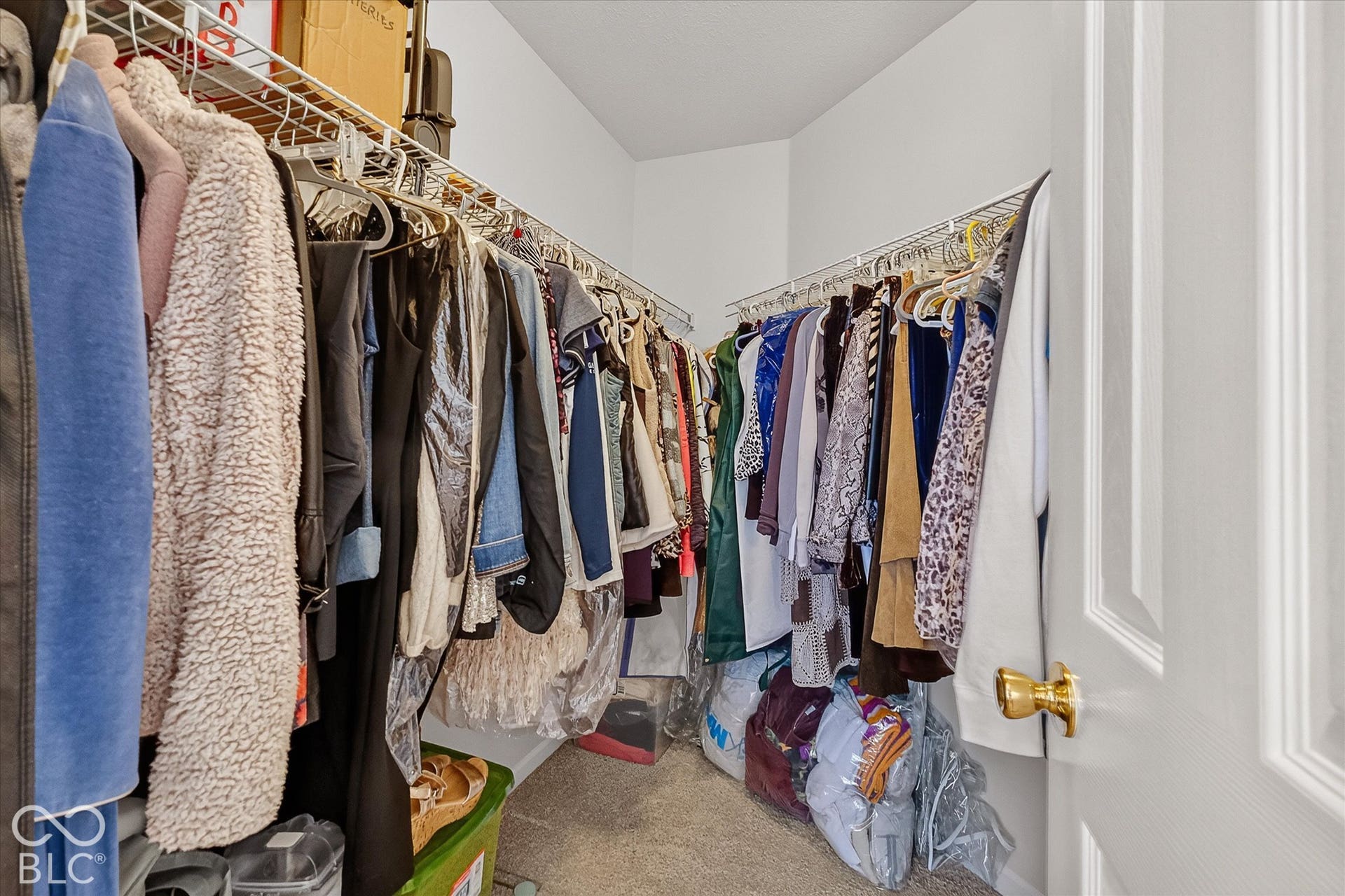 Walk-in closet with fresh paint & new carpet.