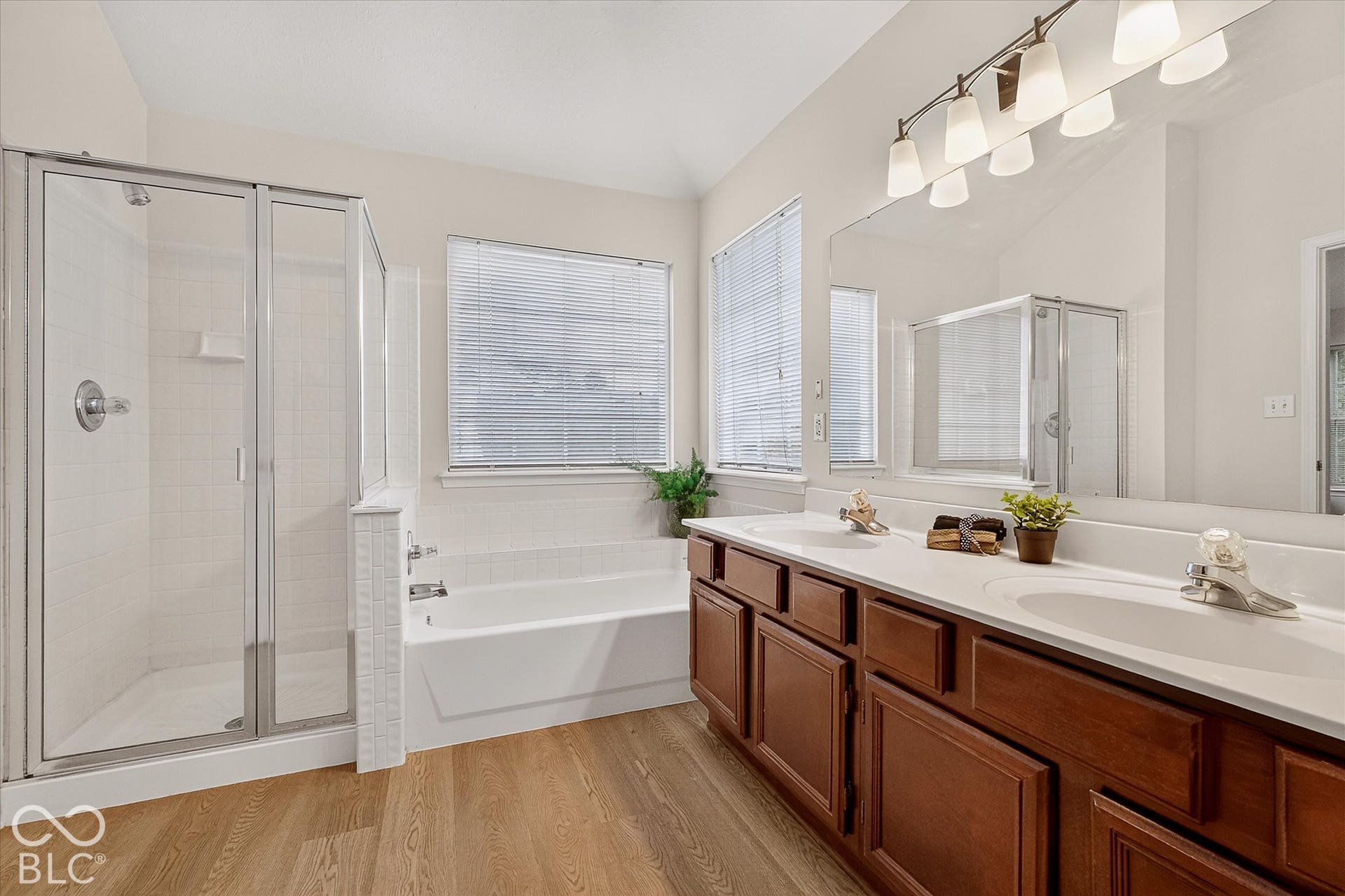 Primary ensuite with double vanities, tub and separate shower, fresh paint & new flooring and lighting.