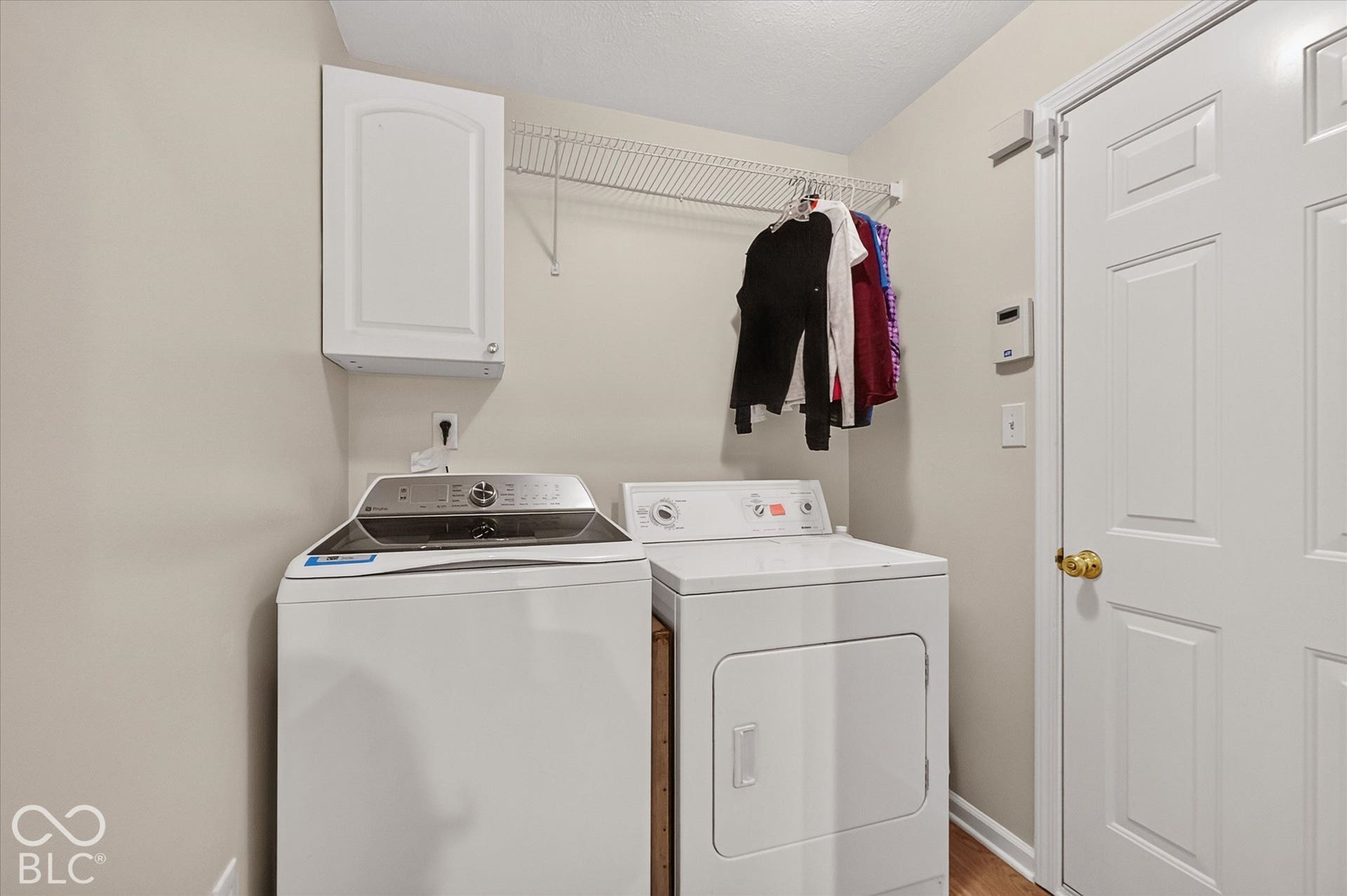 Main floor laundry room with fresh paint, new floor, storage cabinet and appliances included.