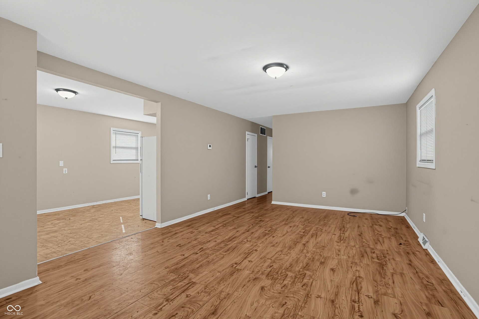 Wood-finish flooring throughout, neutral paint palette, and flush-mount lighting