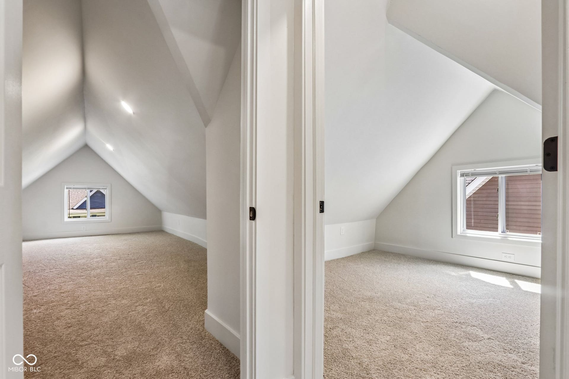 Two distinct rooms featuring vaulted ceilings and neutral carpeting
