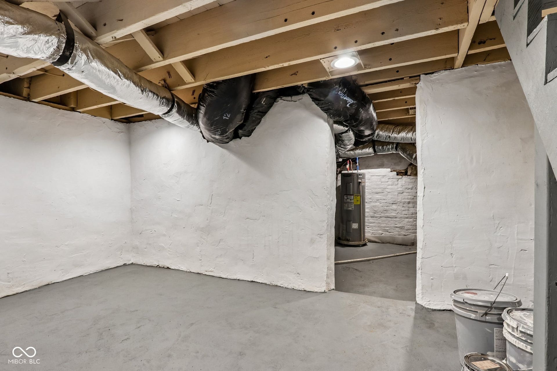 Exposed ceiling joists with visible ductwork and recessed lighting