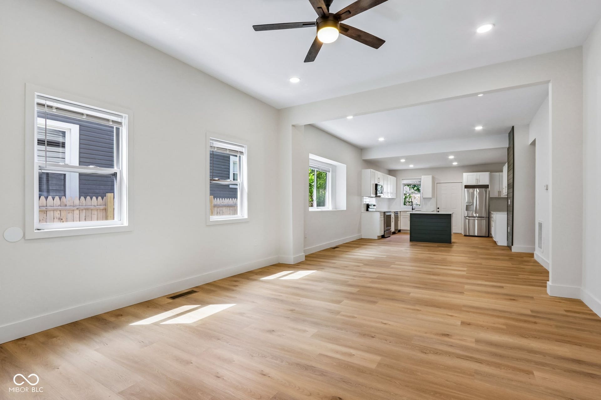 Wood-finish flooring throughout, recessed lighting, and a ceiling fan
