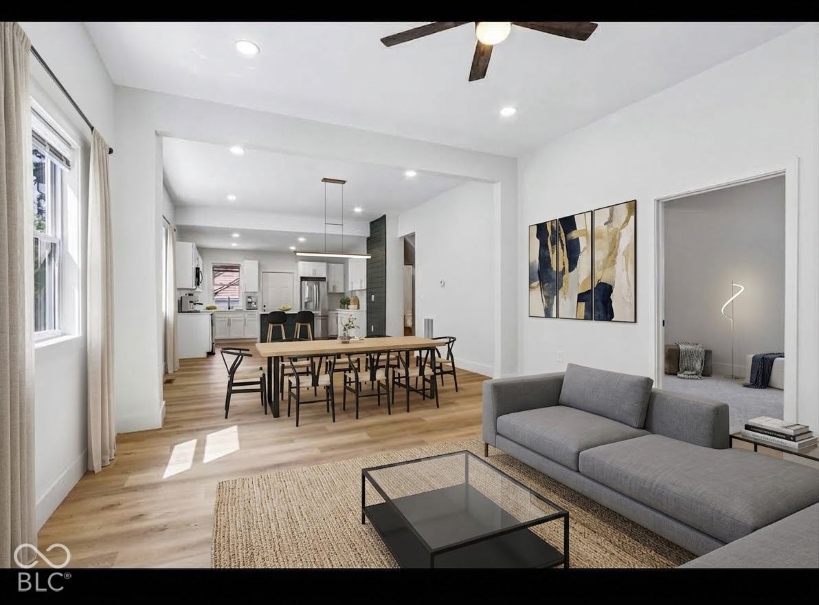 Open-concept living space featuring wood-finish flooring, recessed lighting, and a modern ceiling fan