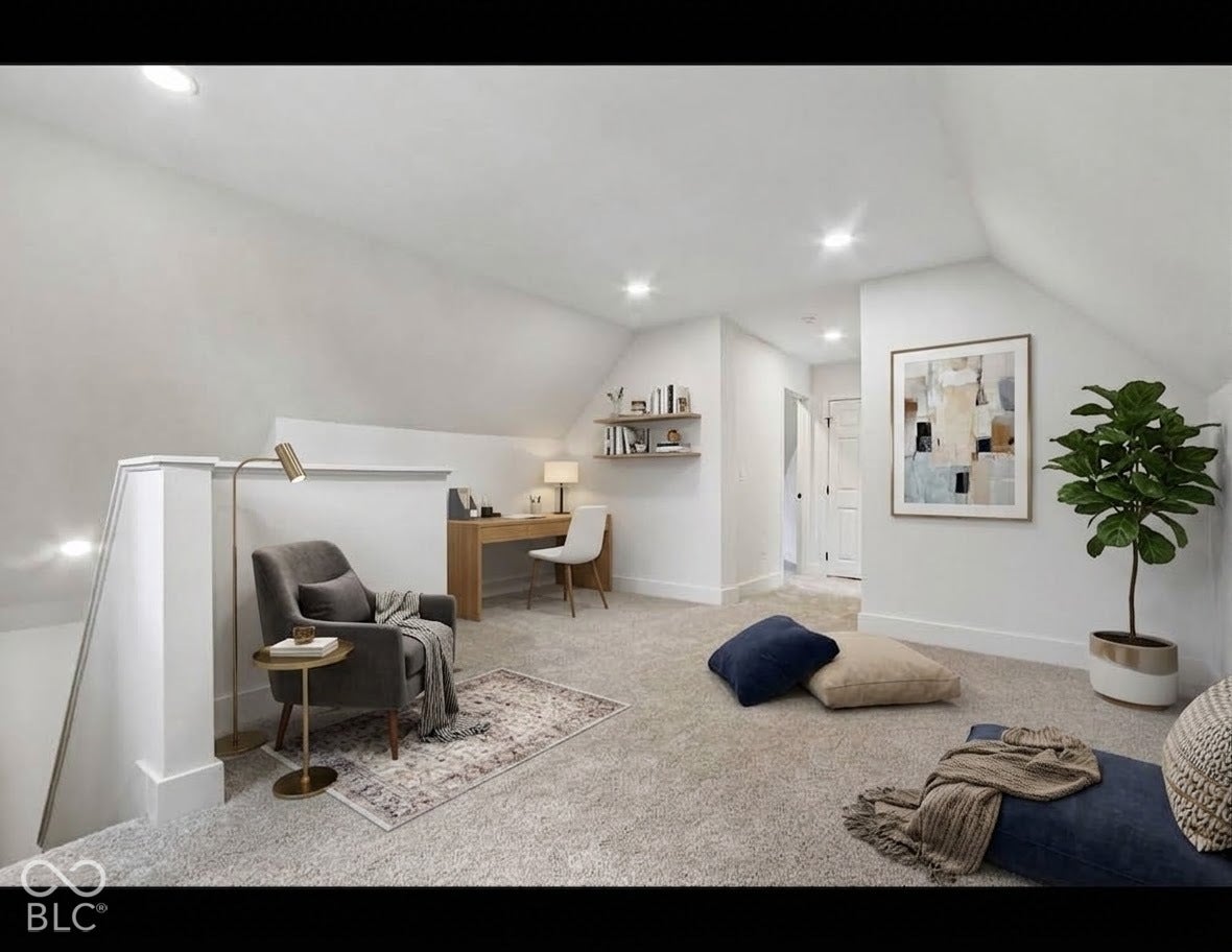 Carpeted loft area with sloped ceilings, recessed lighting, and white baseboards