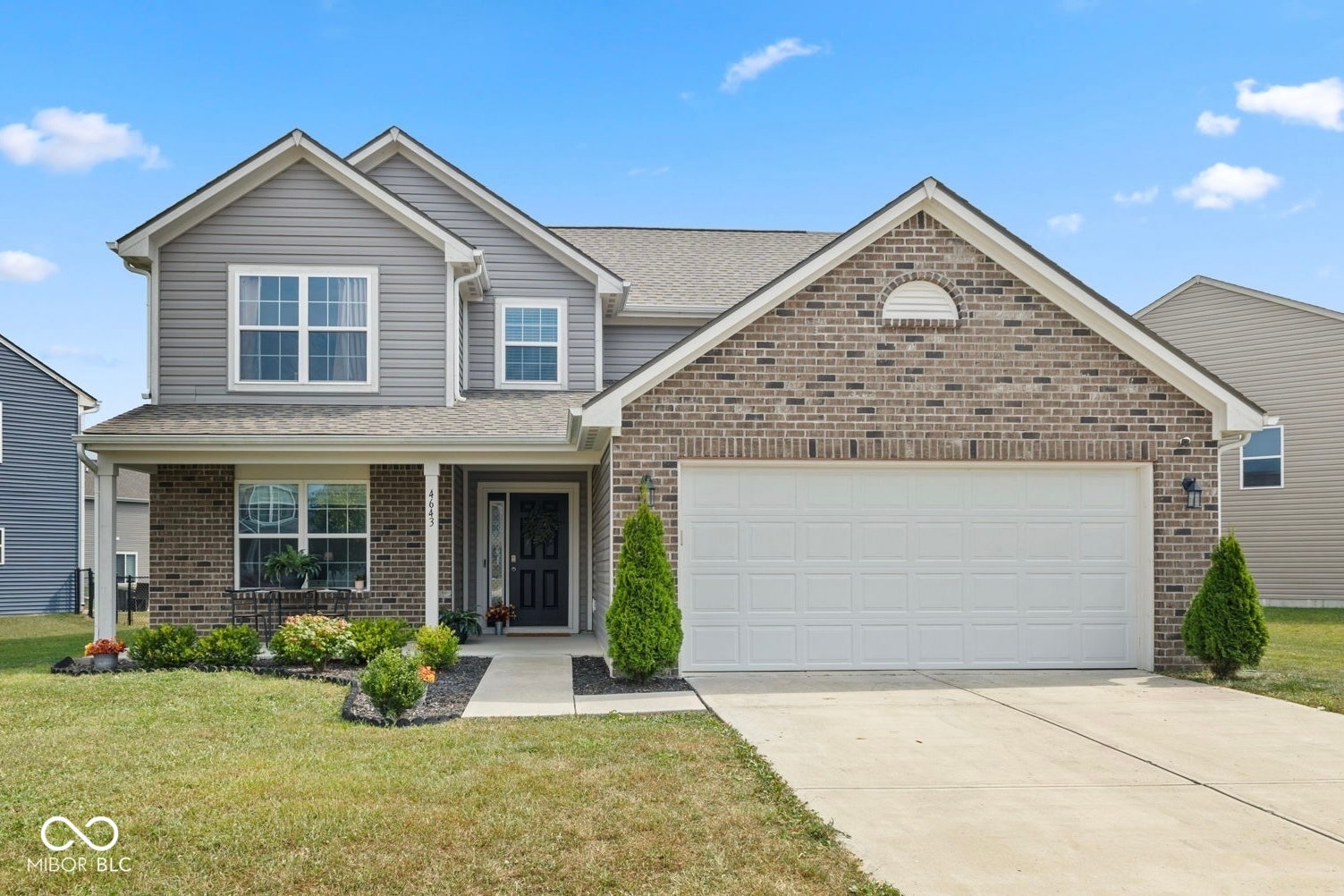 4643 Darla Court, Indianapolis, IN 46239 Two-story exterior with a covered porch, brick and siding facade, attached two-car garage, and concrete driveway