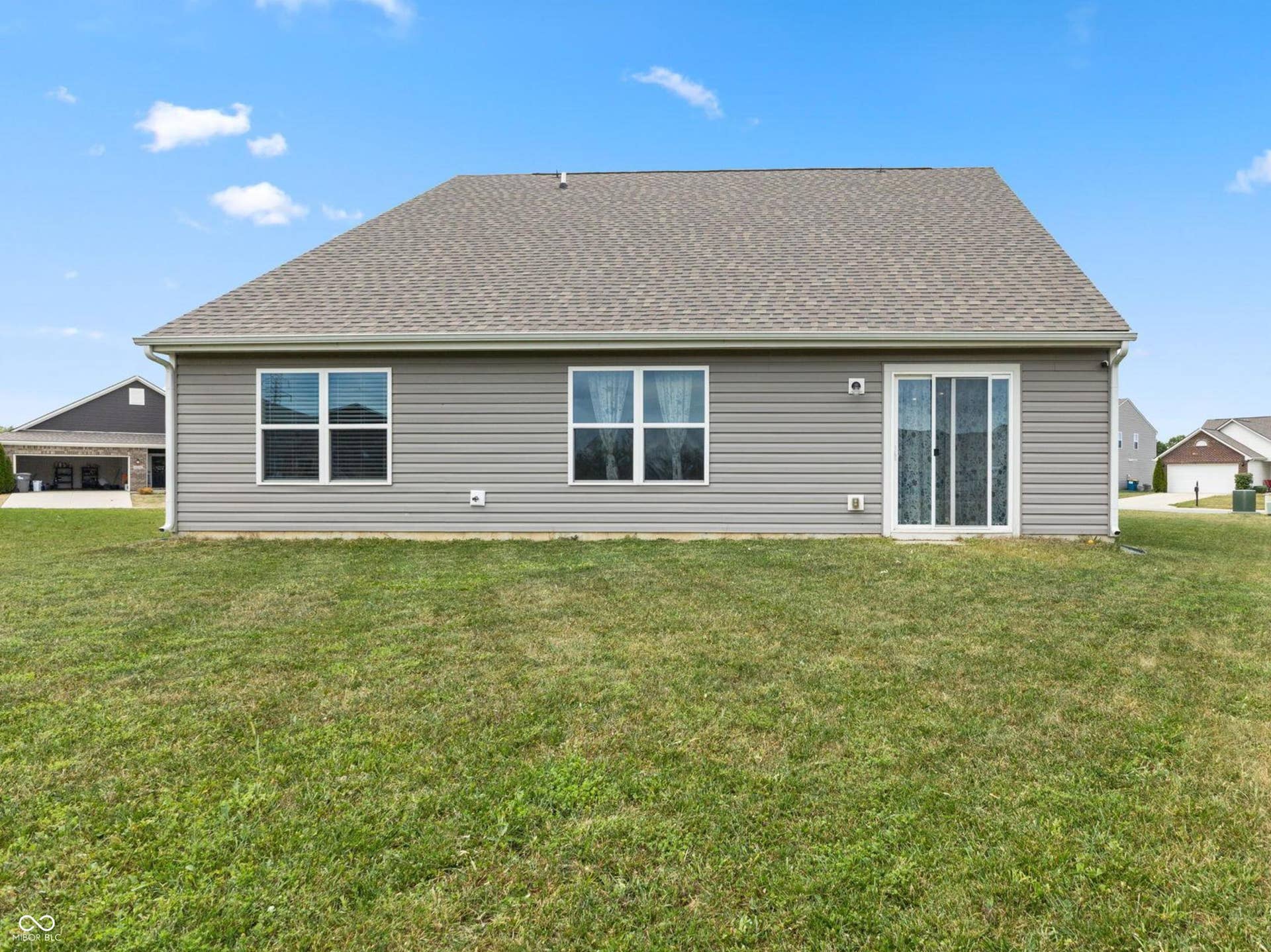 4643 Darla Court, Indianapolis, IN 46239 Rear exterior with horizontal siding, two windows, and a sliding glass door