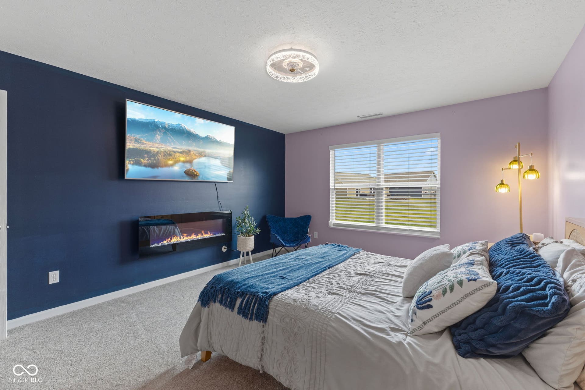 4643 Darla Court, Indianapolis, IN 46239 Wall-mounted electric fireplace, dual-pane window, ceiling-mounted light fixture, and carpeted flooring