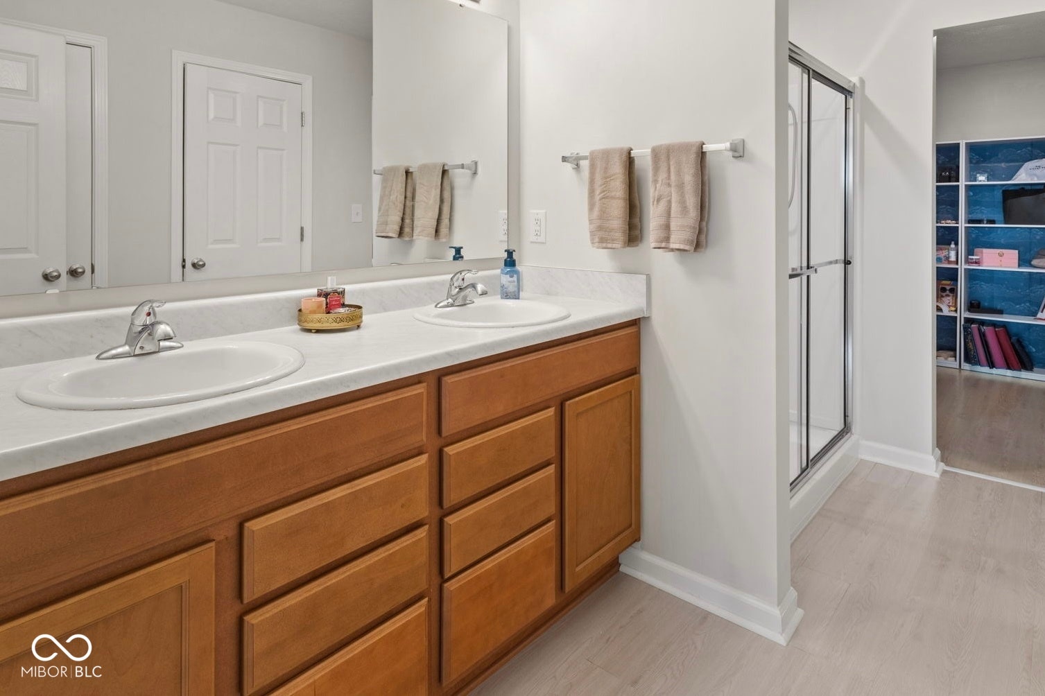 4643 Darla Court, Indianapolis, IN 46239 Dual vanity with wood-finish cabinetry and white countertops