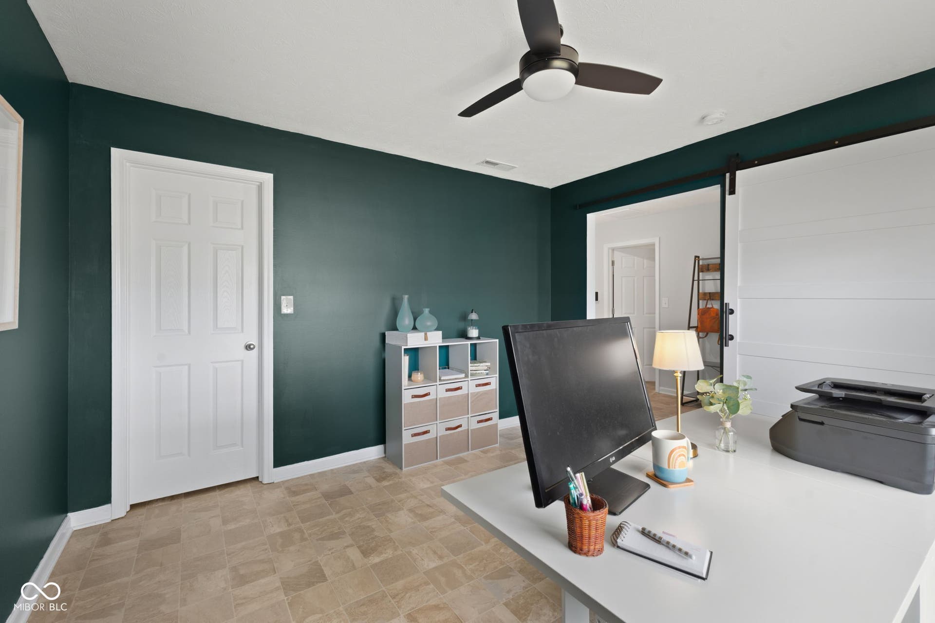 4643 Darla Court, Indianapolis, IN 46239 Ceiling fan with integrated lighting, paneled interior door, barn door entry, and vinyl flooring