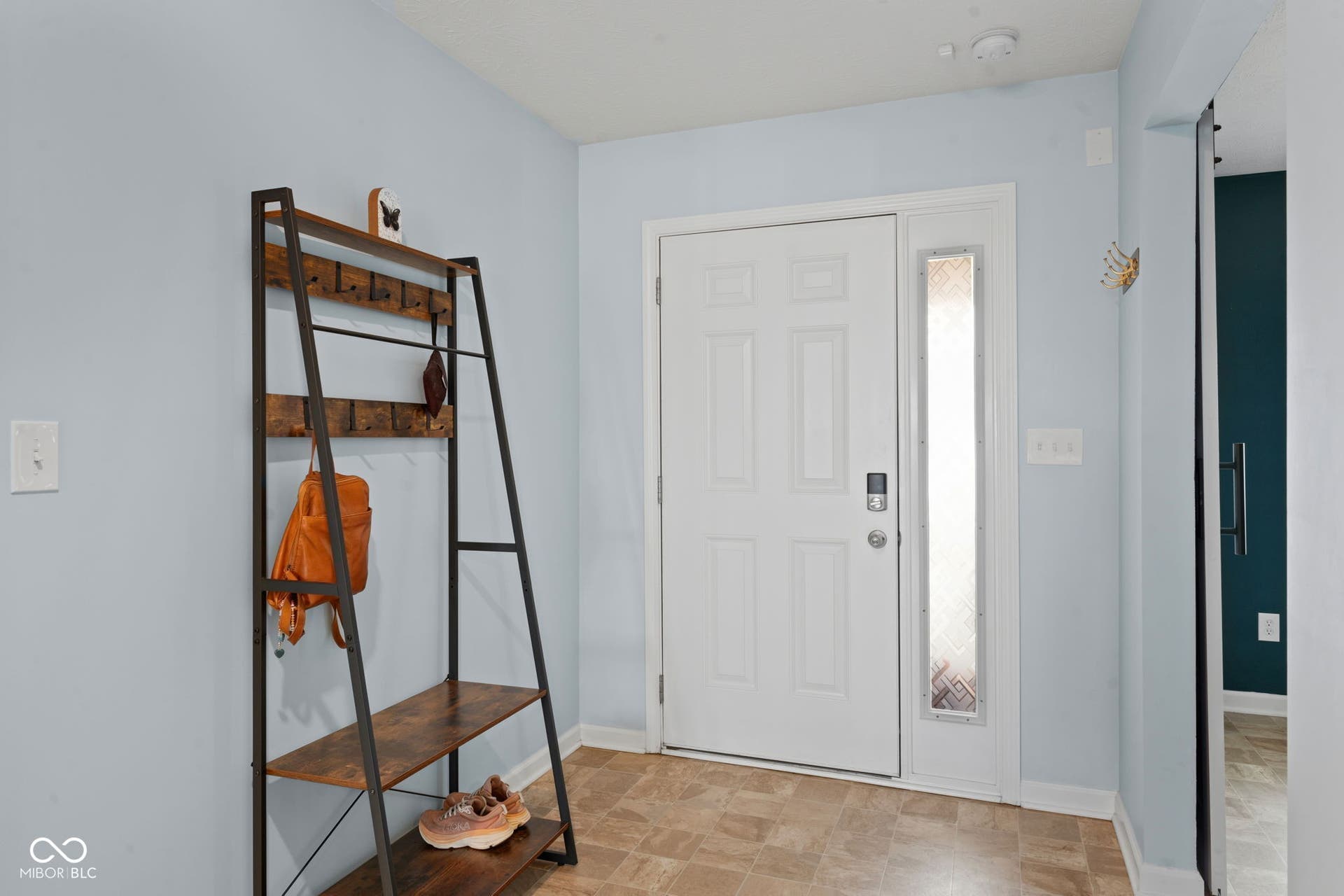 4643 Darla Court, Indianapolis, IN 46239 Entryway featuring a paneled door with sidelight, light blue wall paint, and resilient flooring