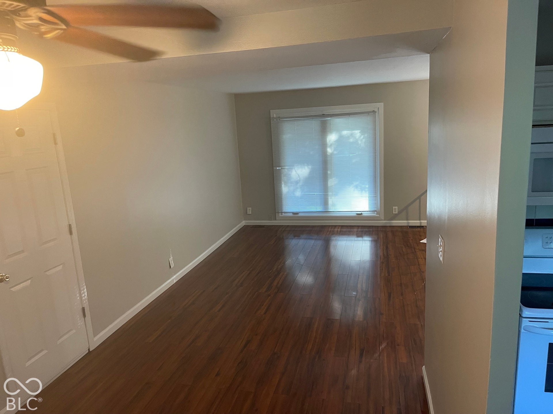 3913 Eisenhower Drive, Indianapolis, IN 46254 Wood-finish flooring throughout, neutral paint finishes, ceiling fan with integrated lighting, and a bright window with blinds