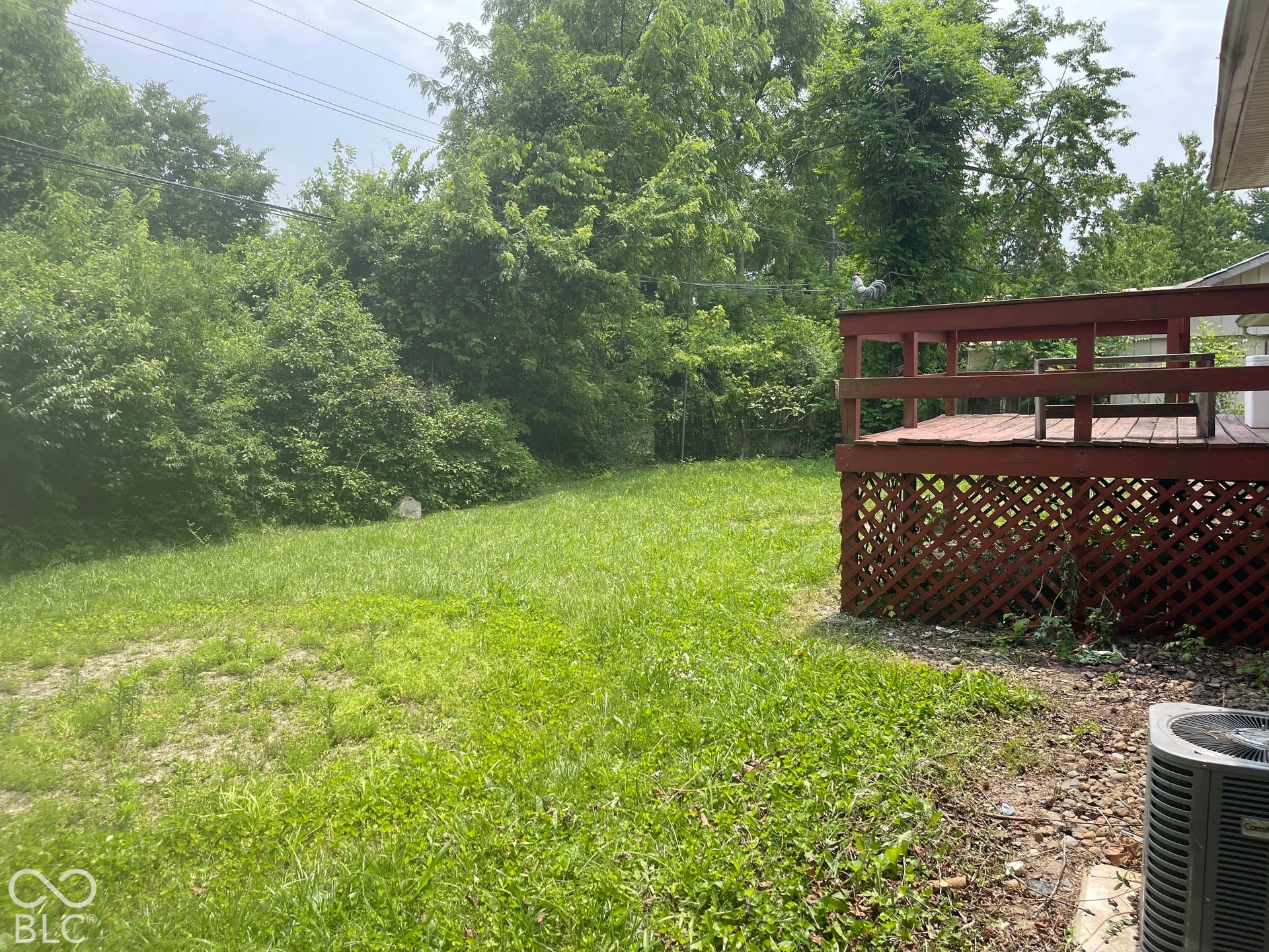 3913 Eisenhower Drive, Indianapolis, IN 46254 Outdoor deck with wood railings and lattice skirting